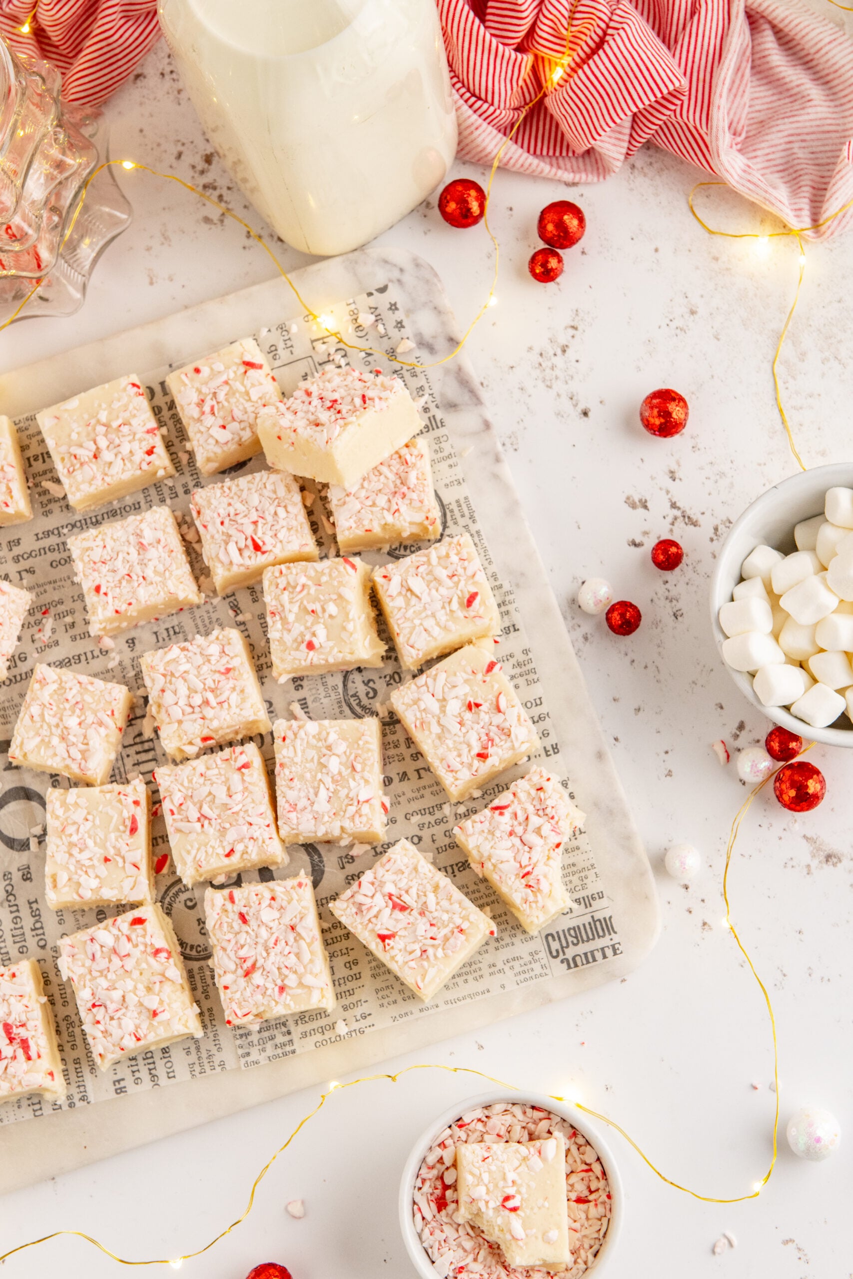 Peppermint fudge cut up into small squares topped with crushed peppermint.