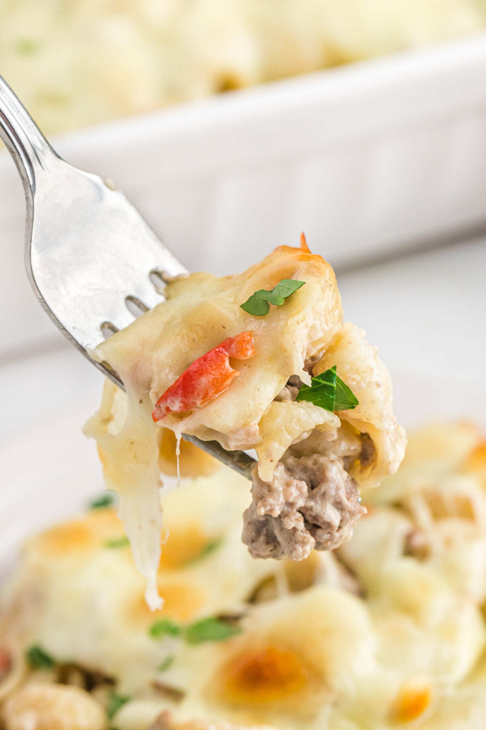 Up close view of Philly Cheesesteak Casserole on a silver fork.