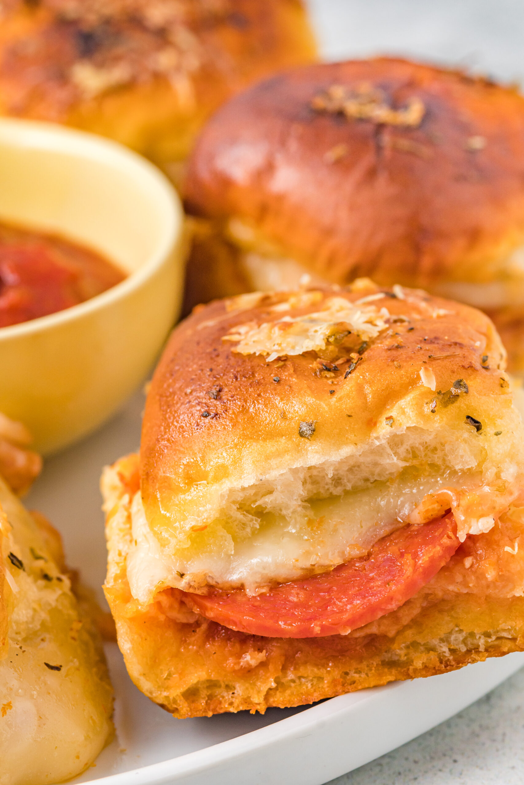 Close up side view of a pizza slider.