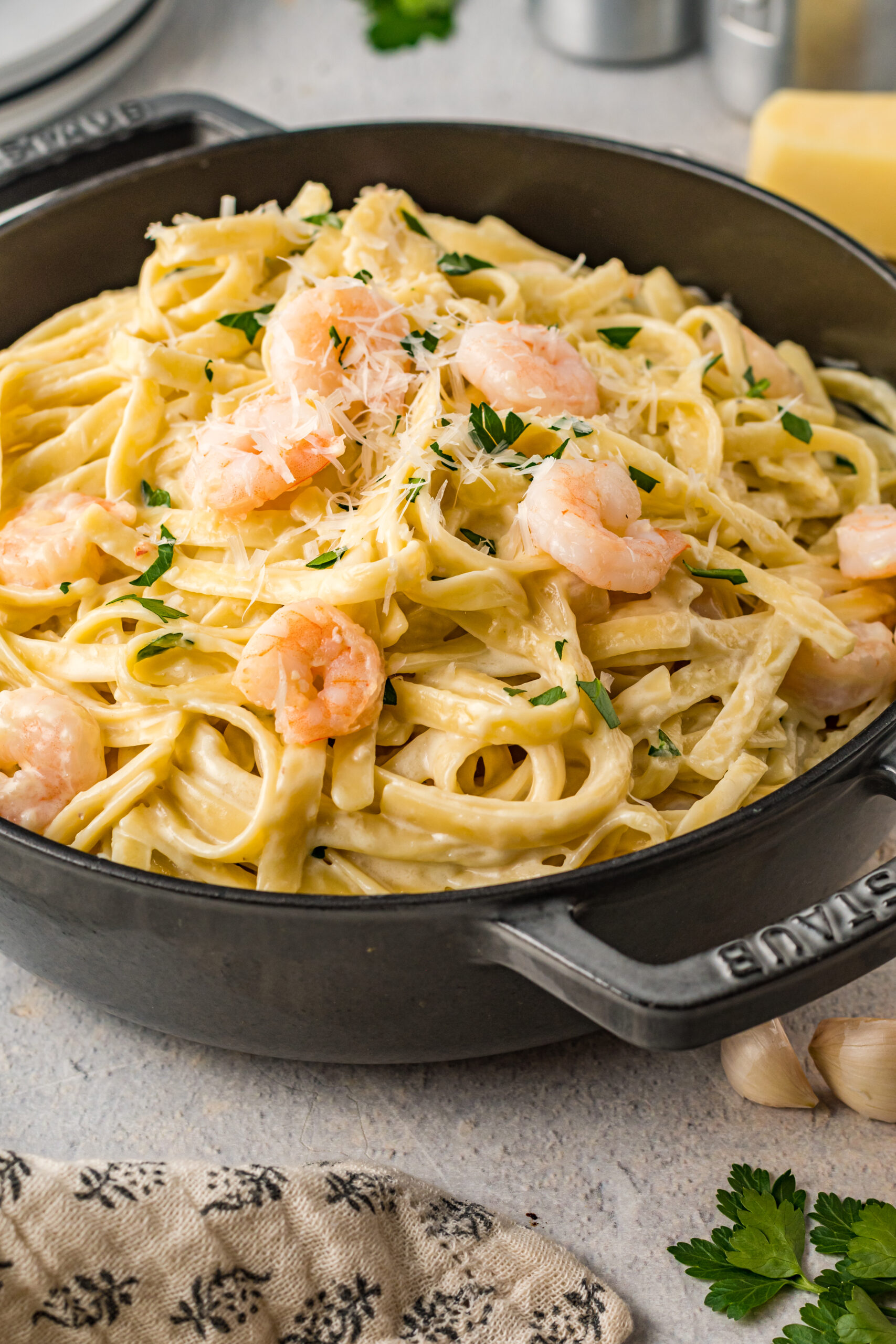 Front view of Shrimp Alfredo in a black cast iron pot.