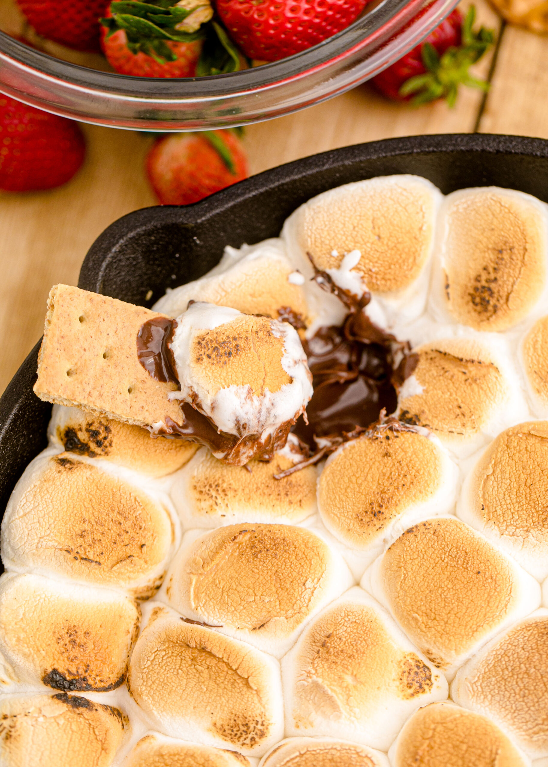 S'mores Dip with a graham cracker scooping some out of the pan
