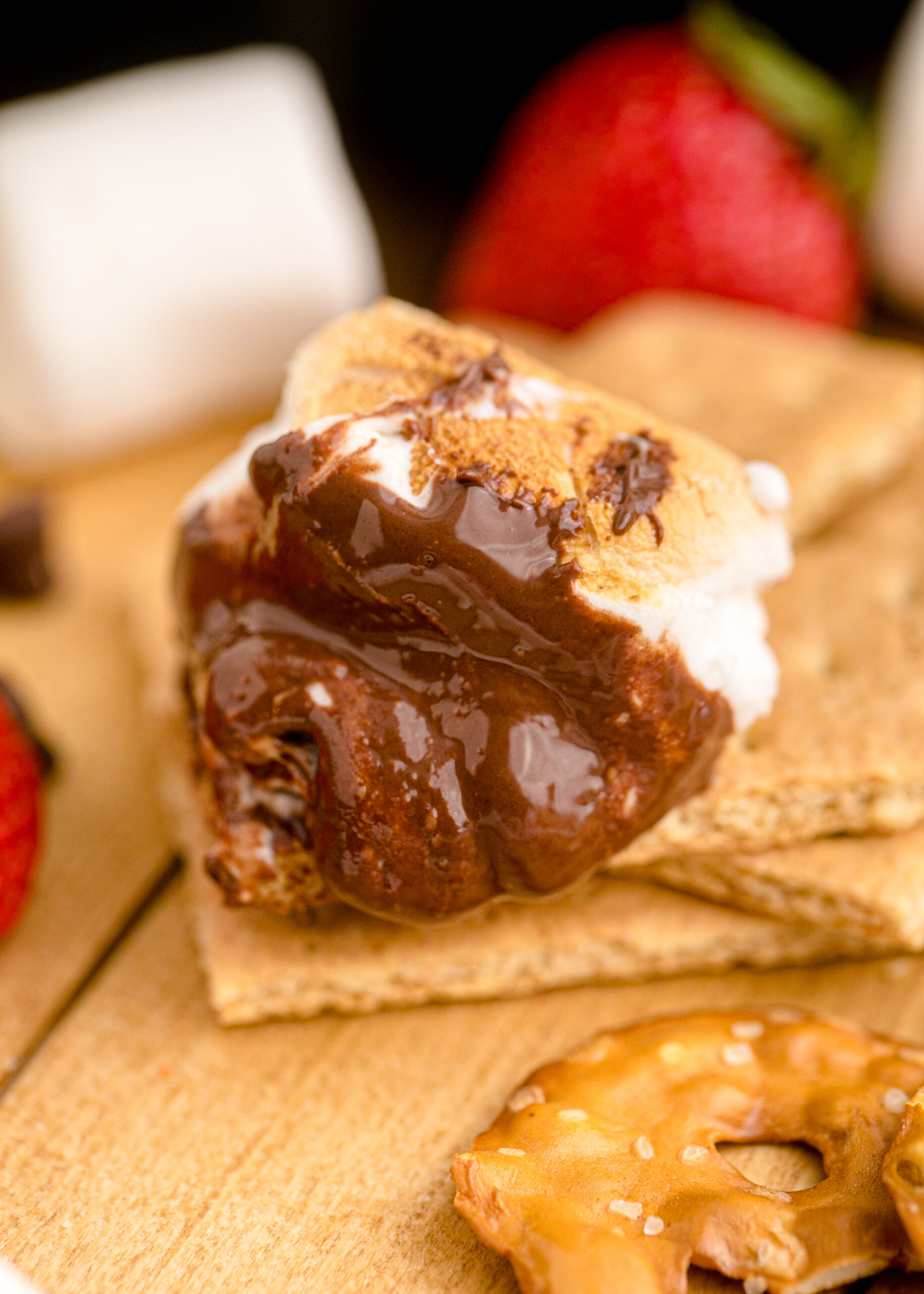 Close up view of a graham cracker covered in the S'mores dip.