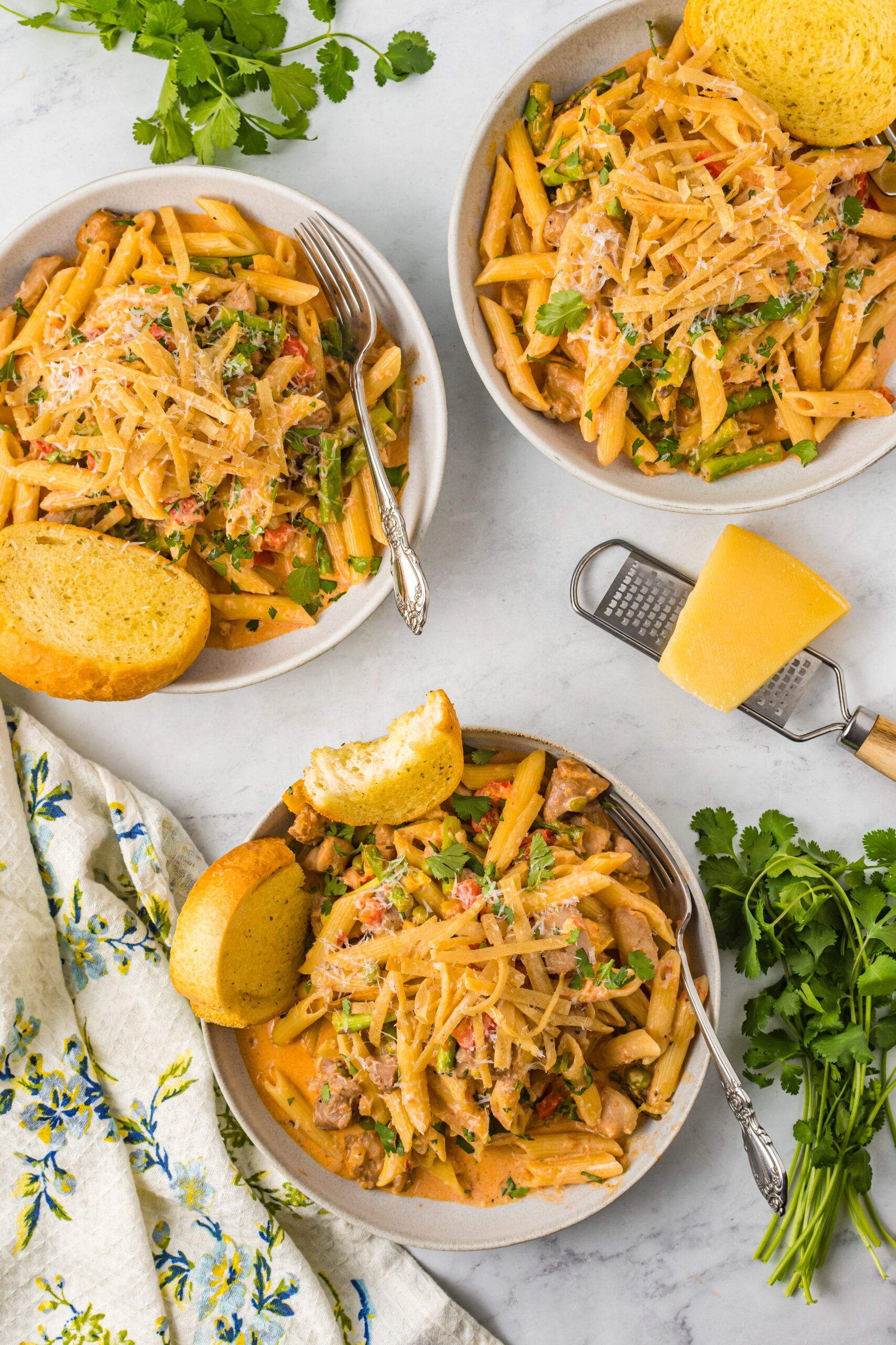 Overhead view of Cajun Chicken Pasta served in a dish with garlic bread.