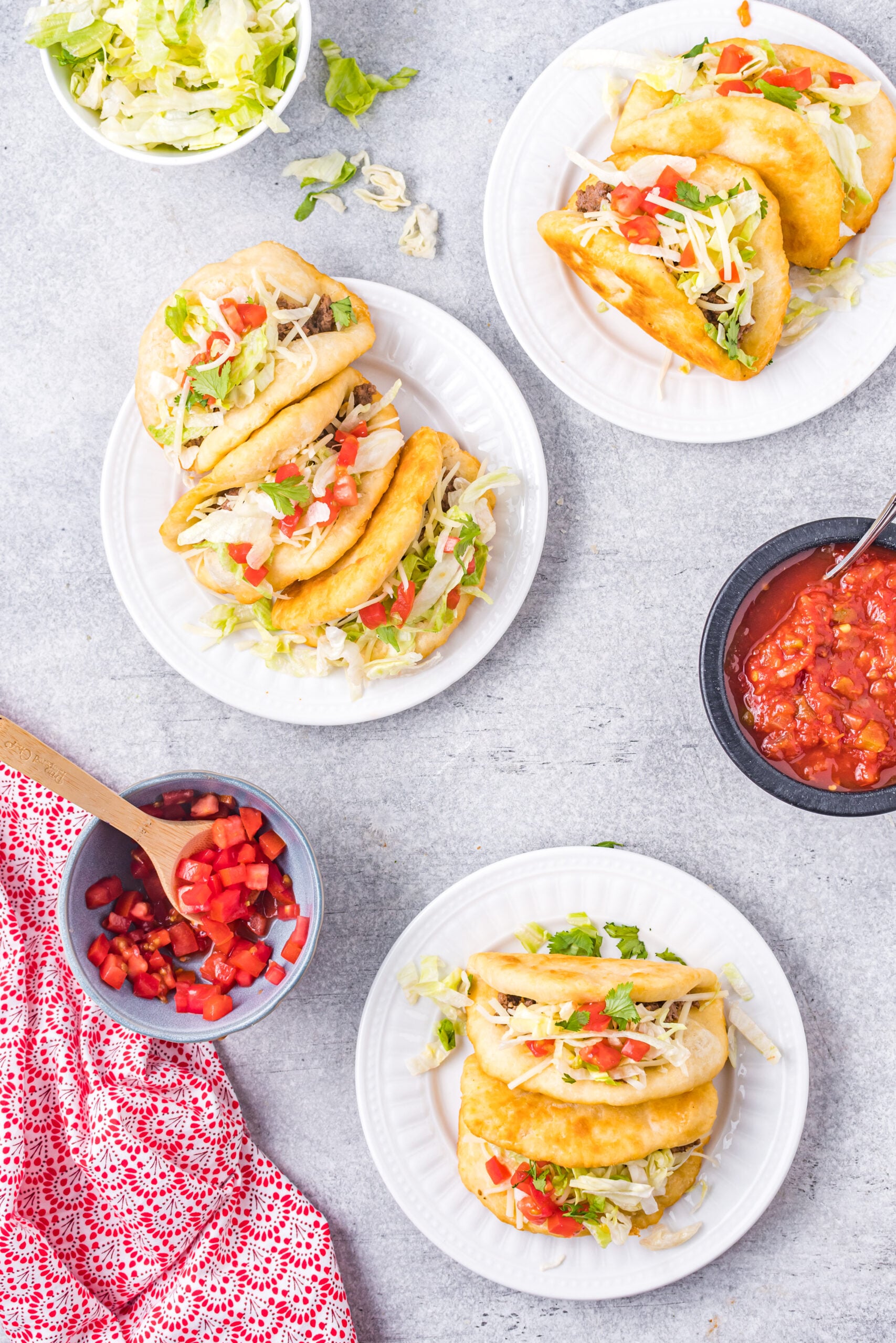Overhead view of Taco Bell Chalupas served on white plates.
