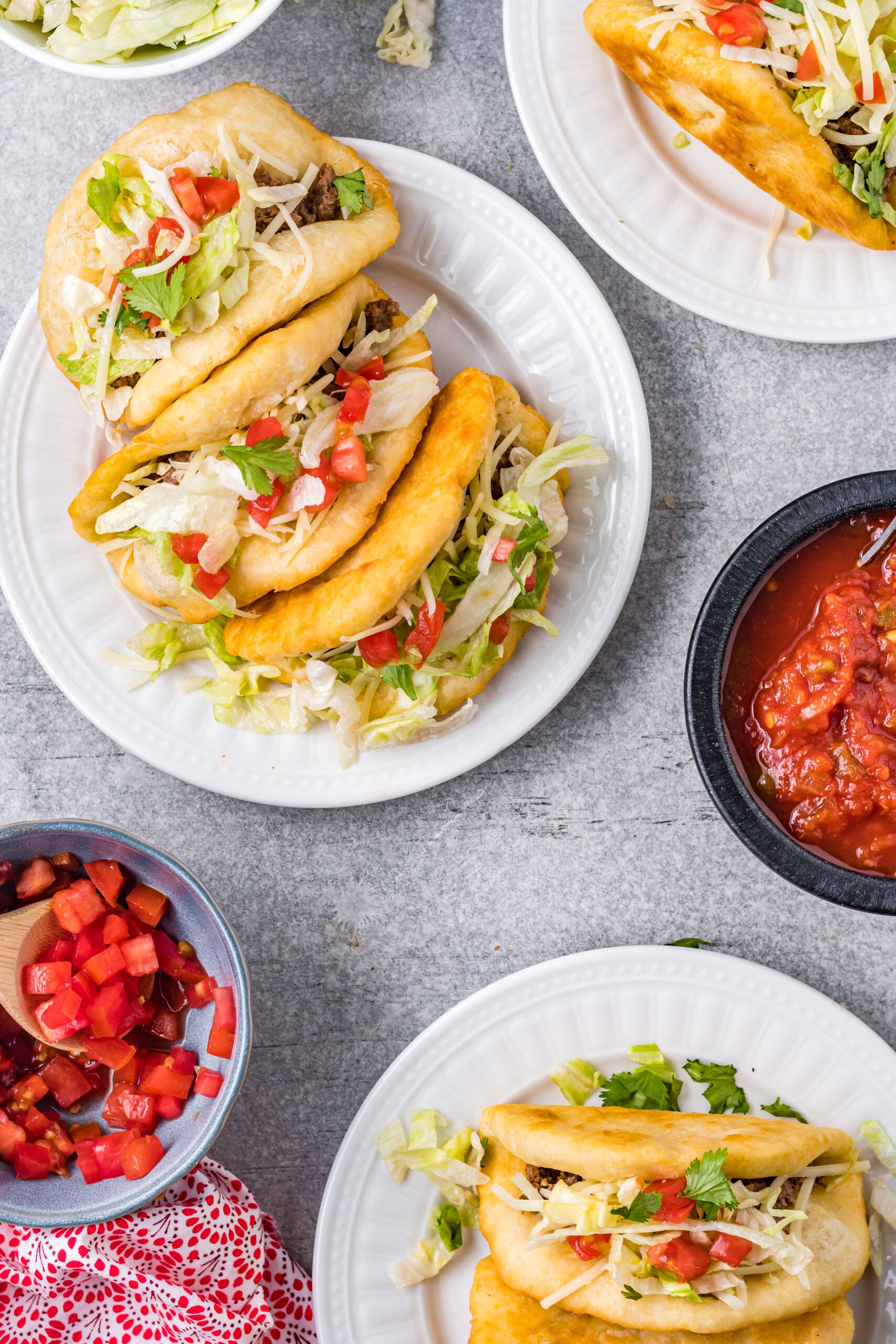 Overhead view of Taco Bell Chalupas served on white plates.