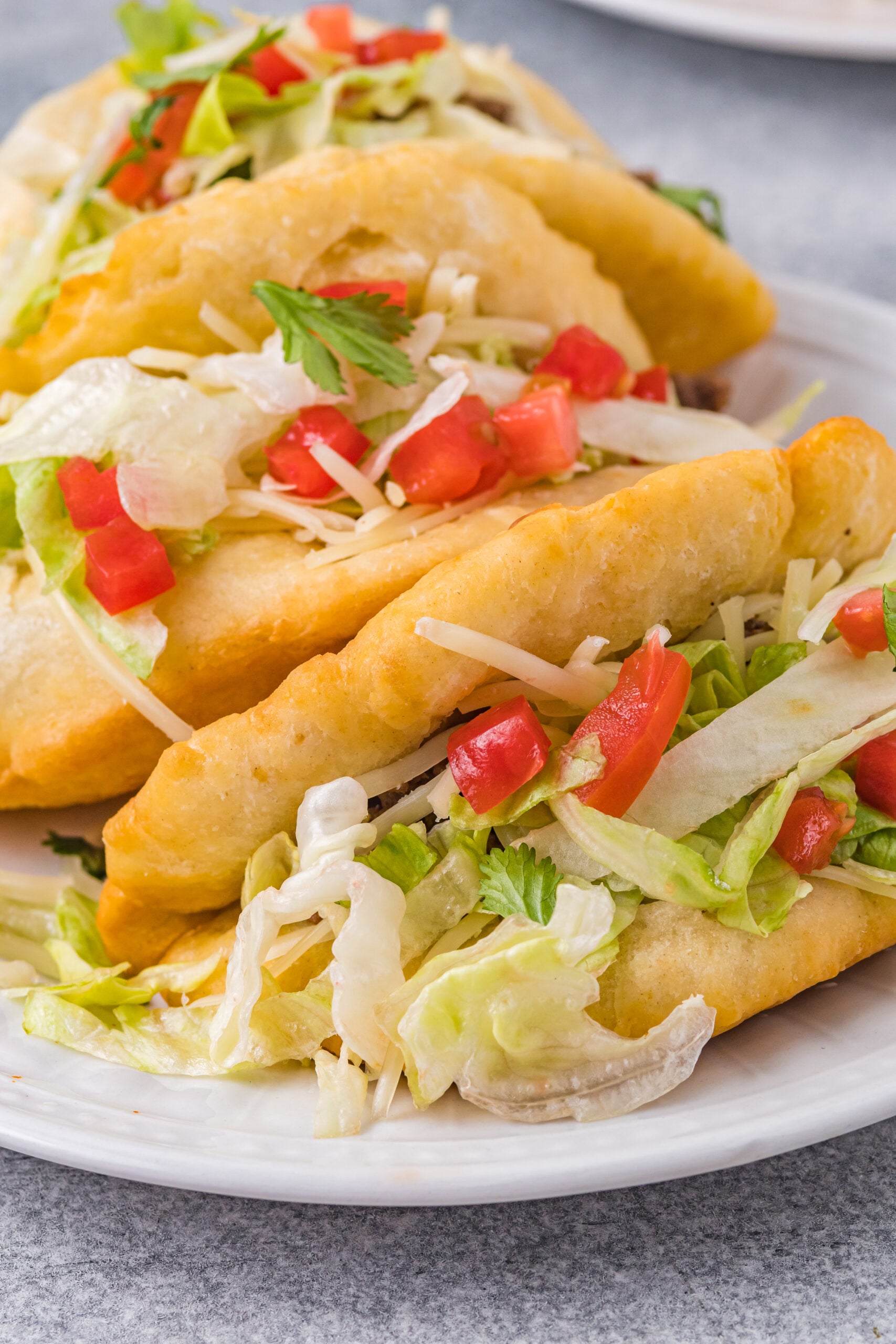Up close view of Taco Bell Chalupas on a white plate.