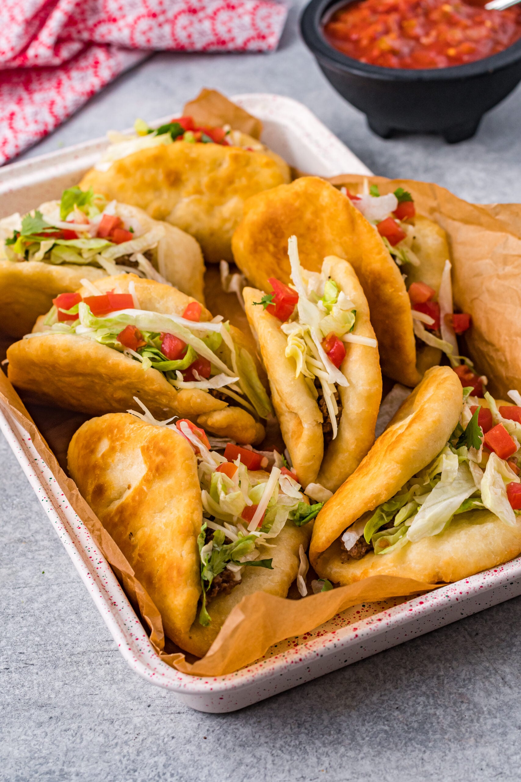 View of Taco Bell Chalupas in a serving tray lined with parchment paper.