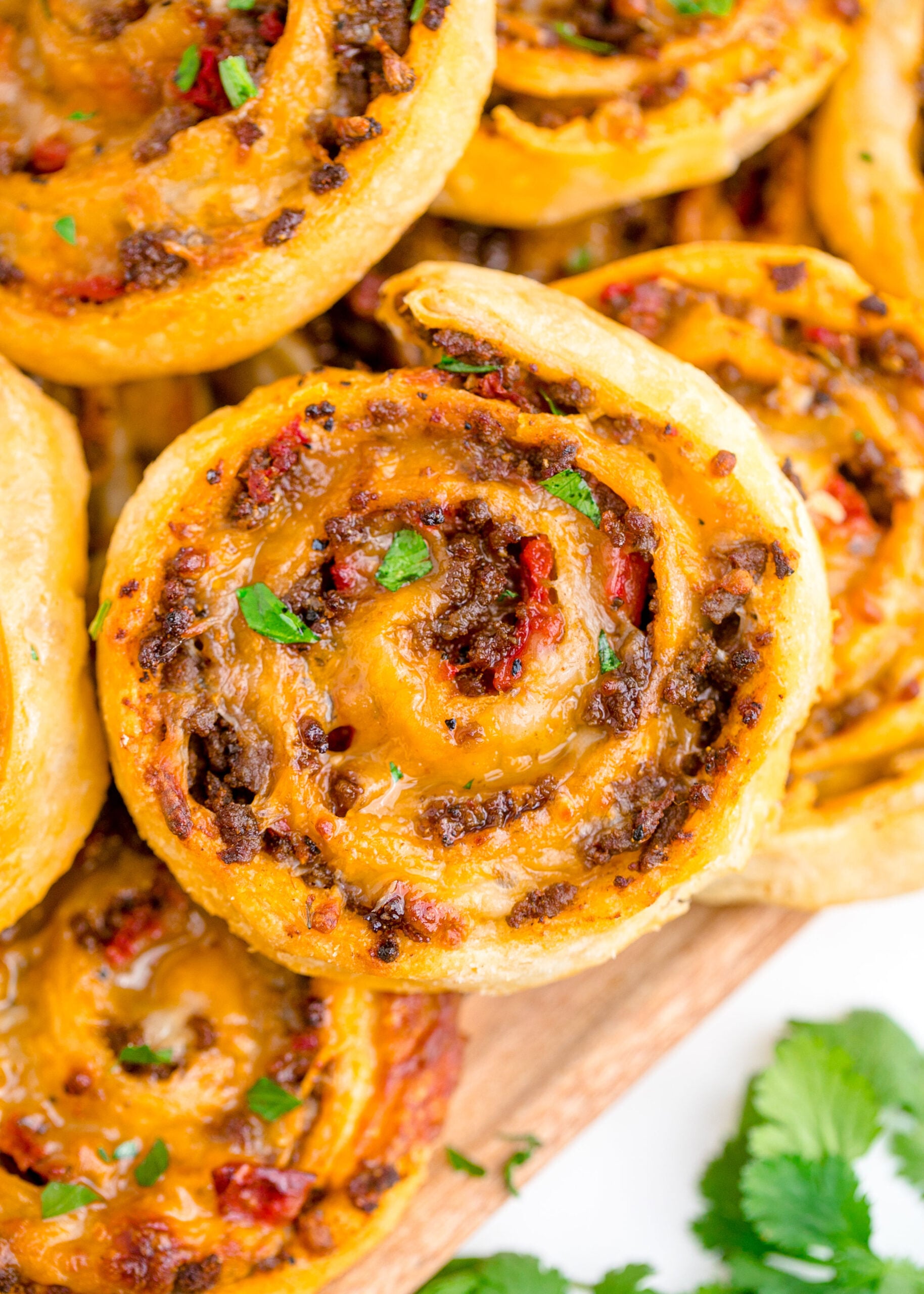 Taco pinwheels up close on a wood board