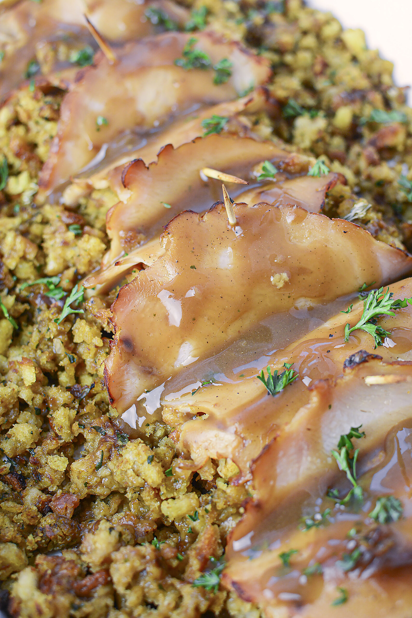 Up Close view of turkey stuffing rolls topped with gravy. 