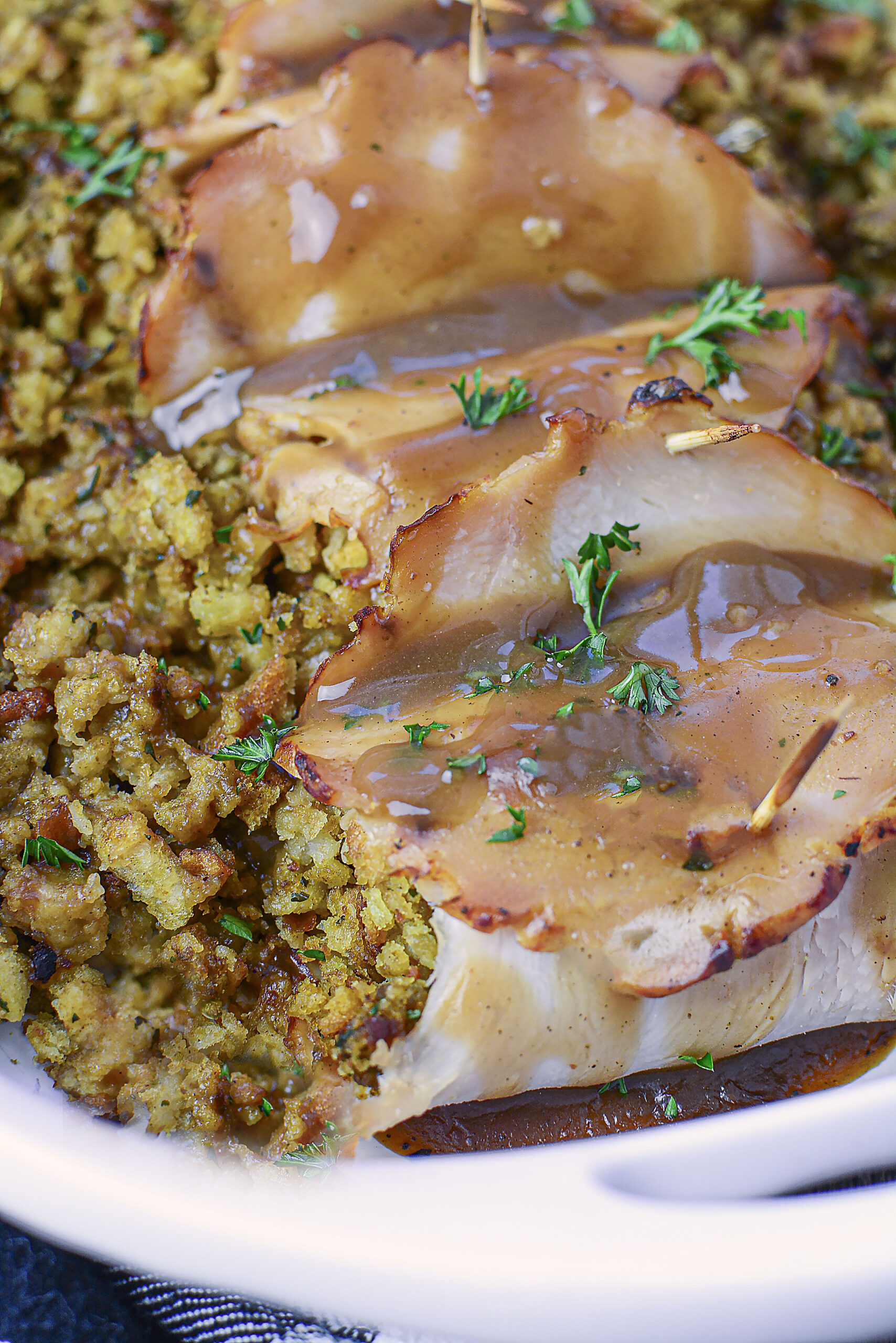 Up Close view of turkey stuffing rolls topped with gravy. 