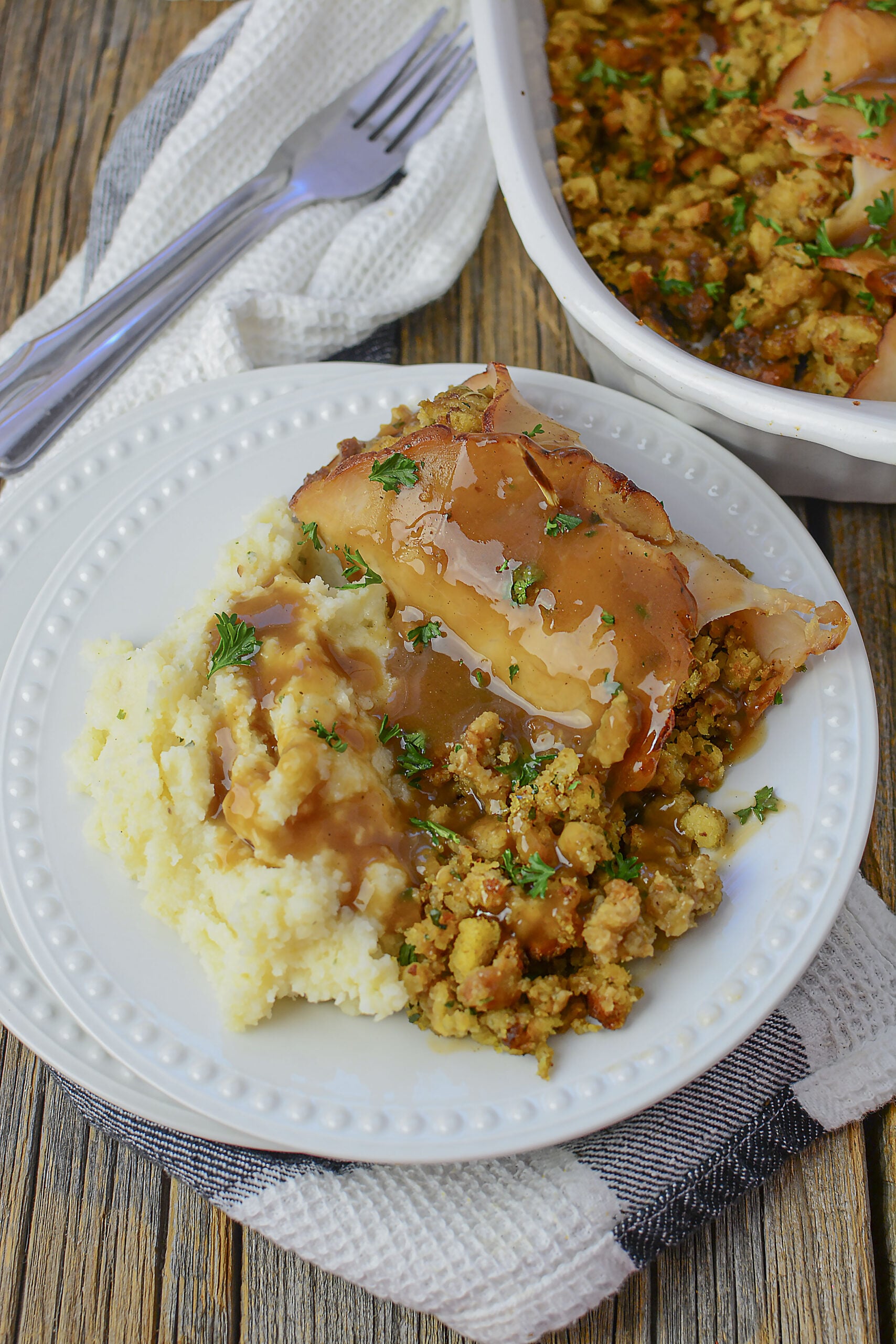 Turkey Stuffing Rolls on a white plate with mashed potatoes and gravy.