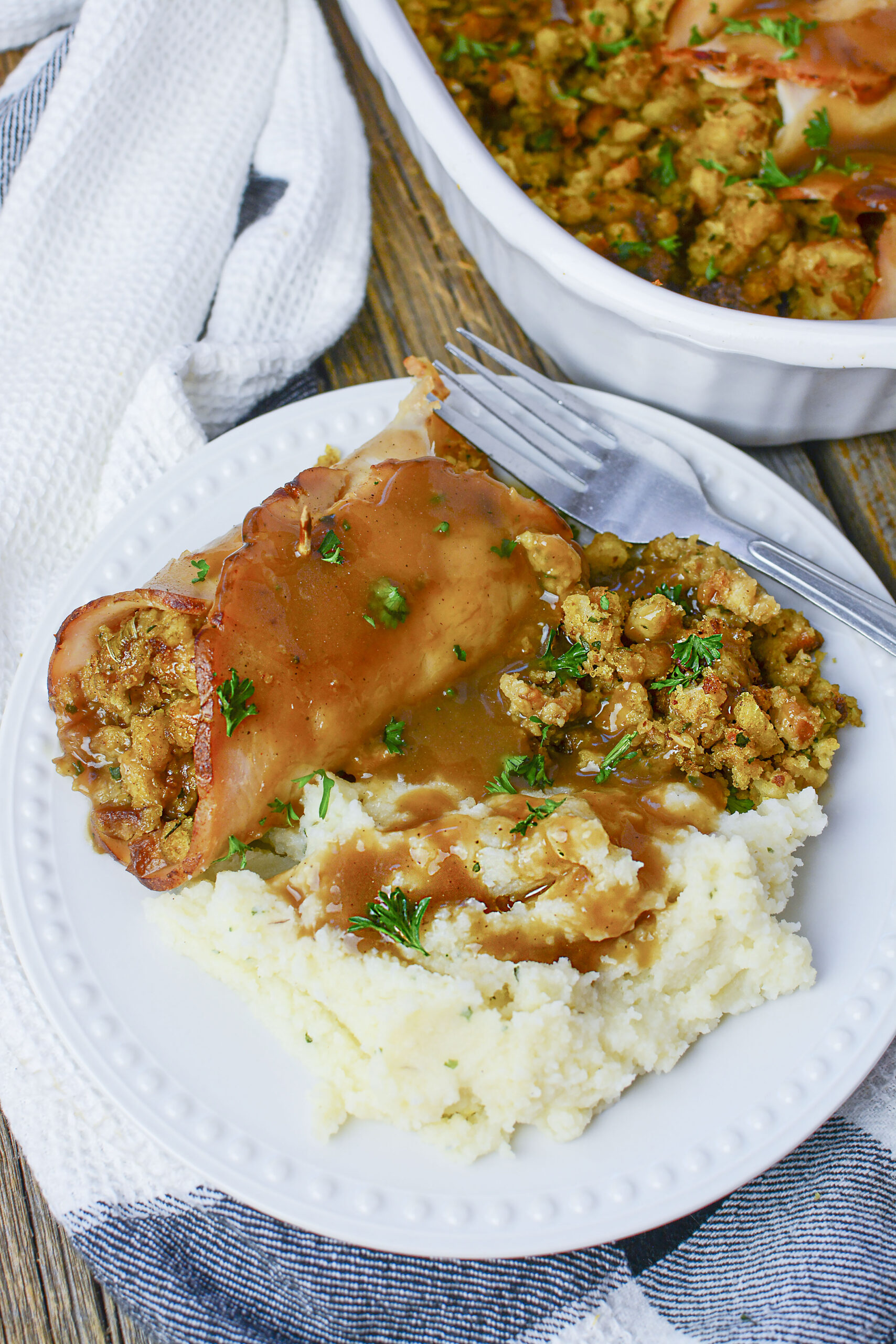 Turkey Stuffing Rolls on a white plate with mashed potatoes and gravy.