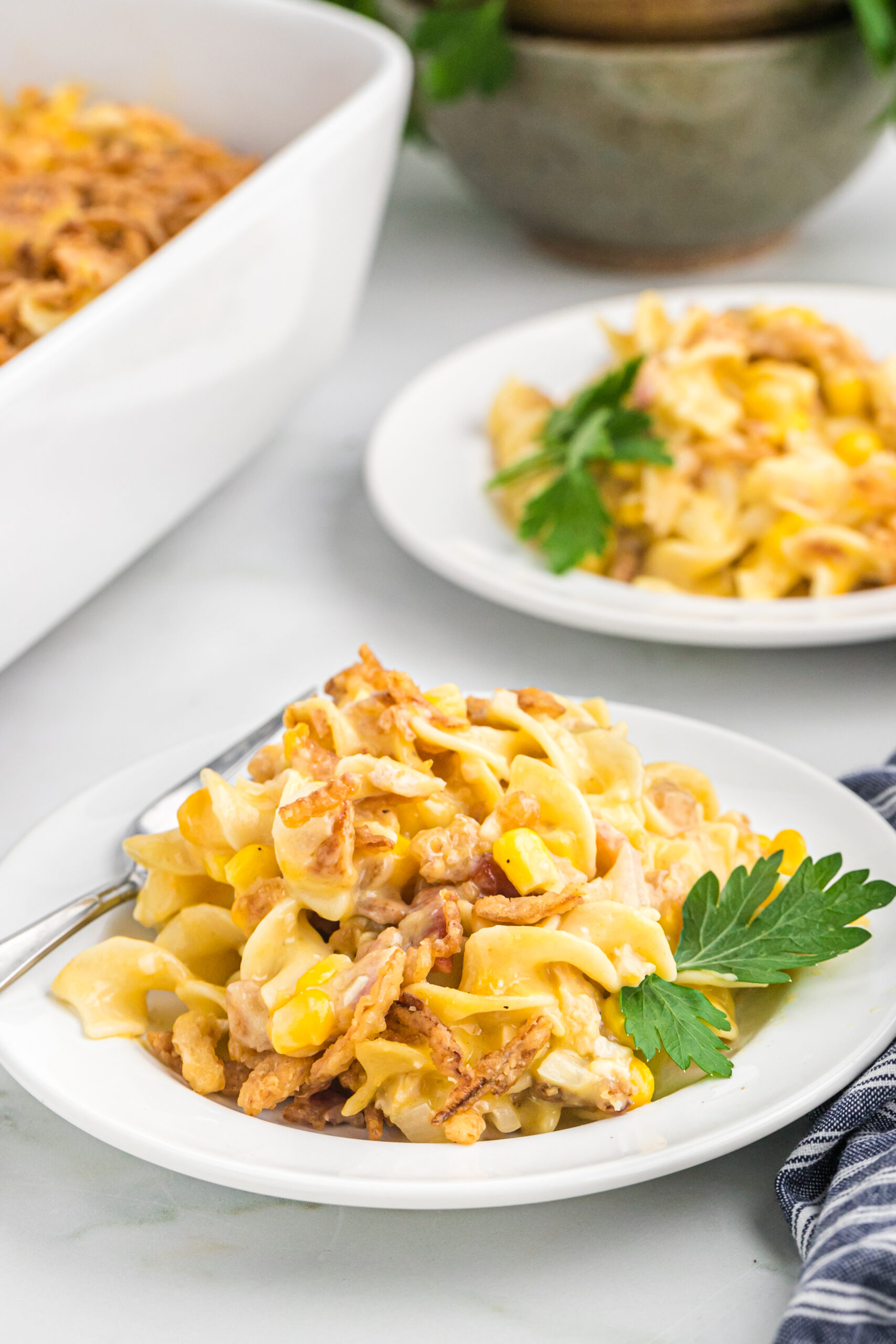 Front view of a serving of Ultimate Chicken Casserole on a white dish.