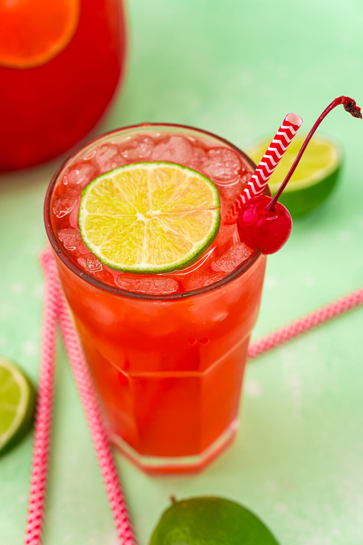45 degree view of Cherry Limeade garnished with a lime and cherry.