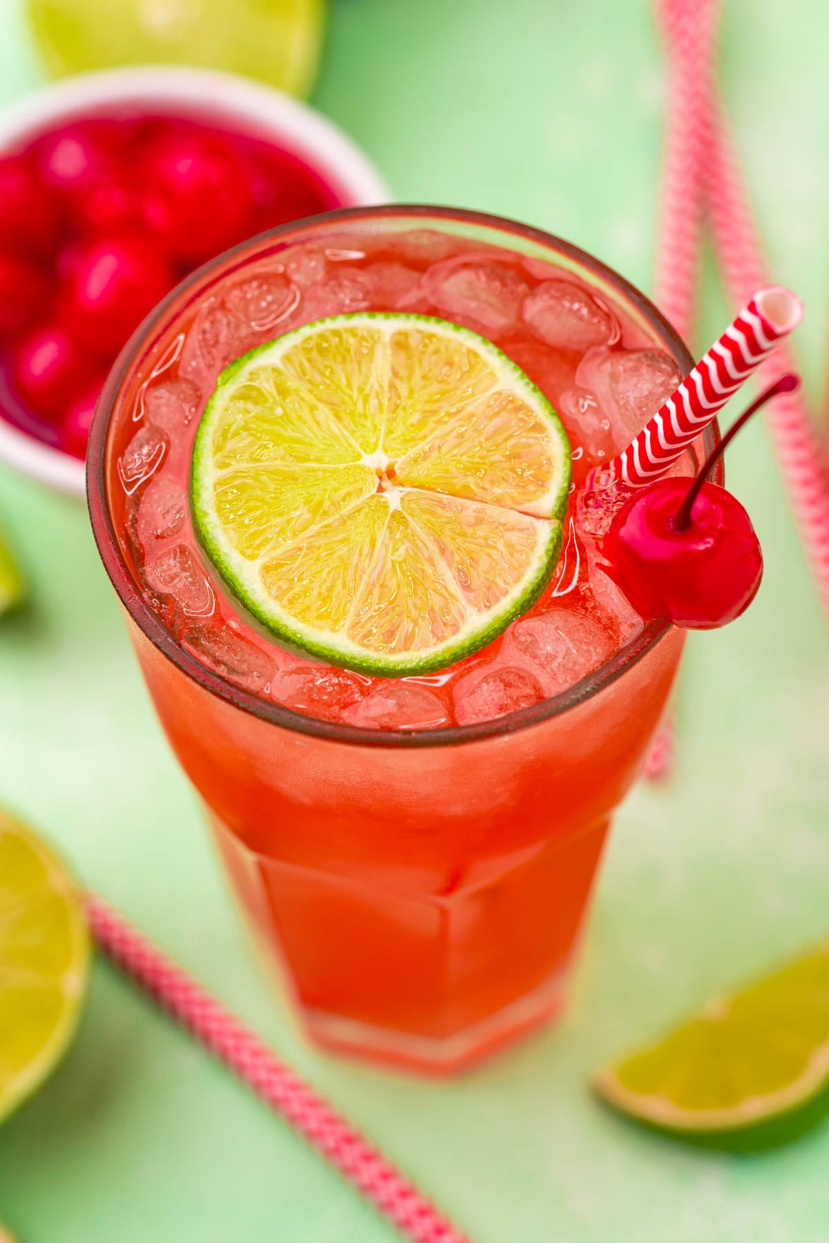 45 degree view of Cherry Limeade garnished with a lime and cherry.