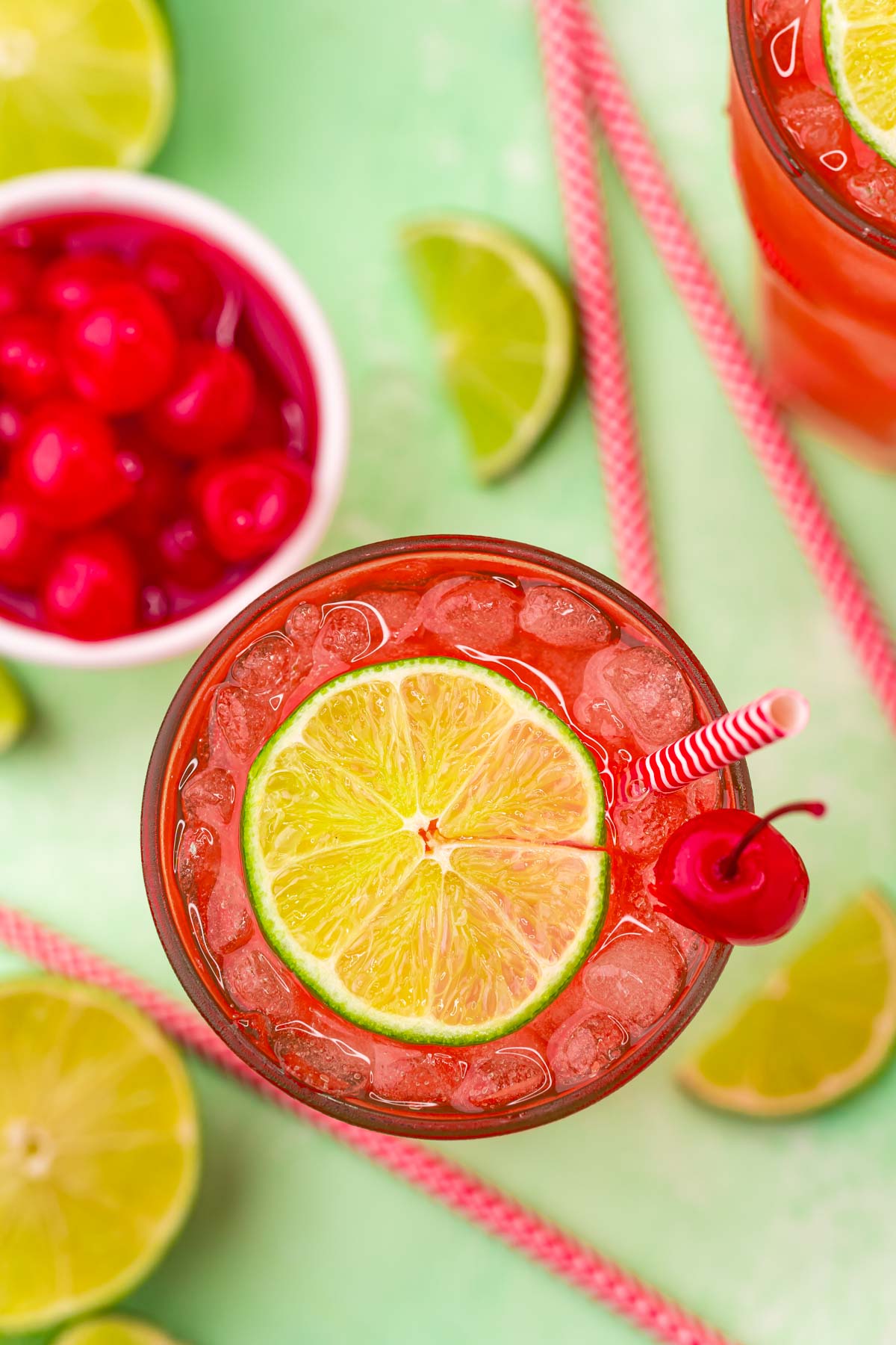 Overhead view of Cherry Limeade garnished with a lime and cherry.