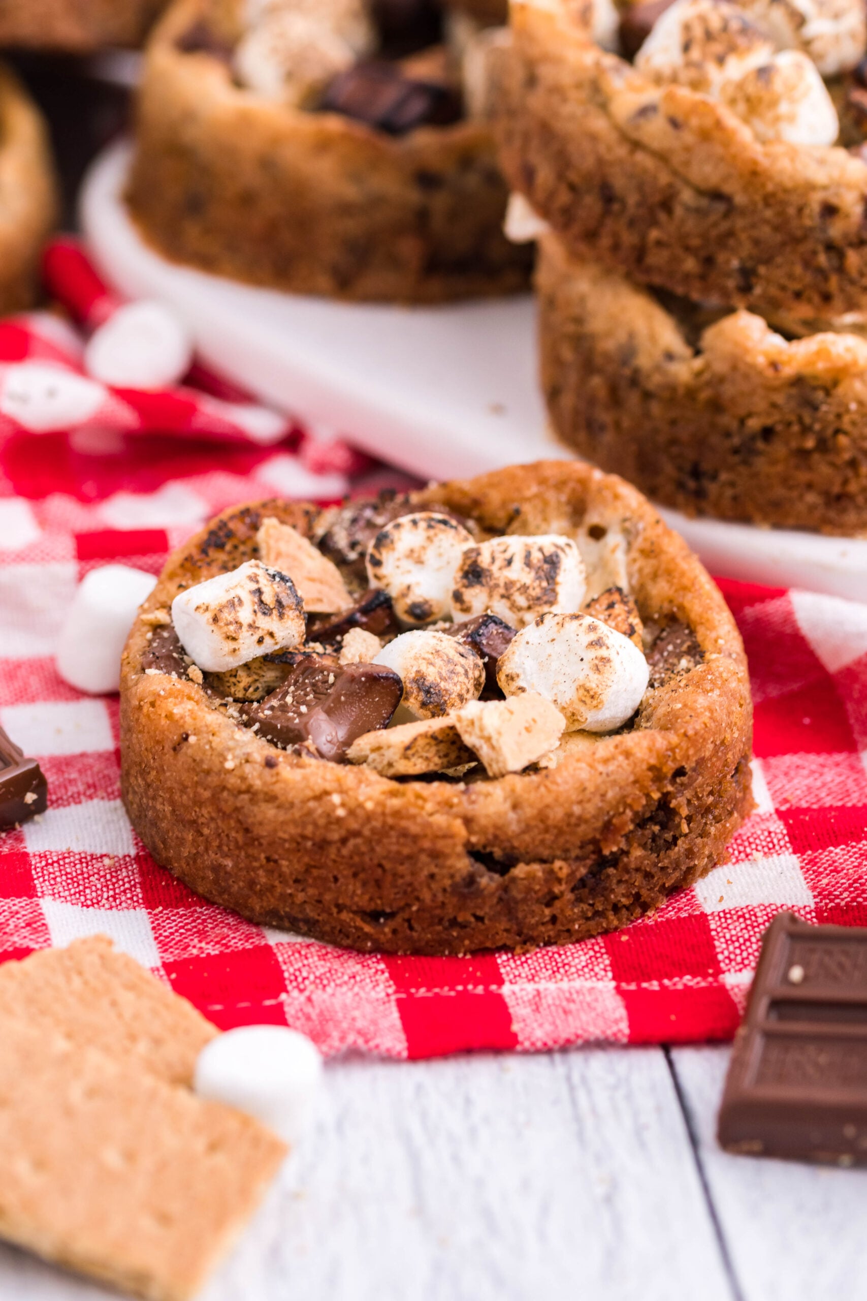 Front view of Deep Dish S’mores Cookies on red checkered linen.