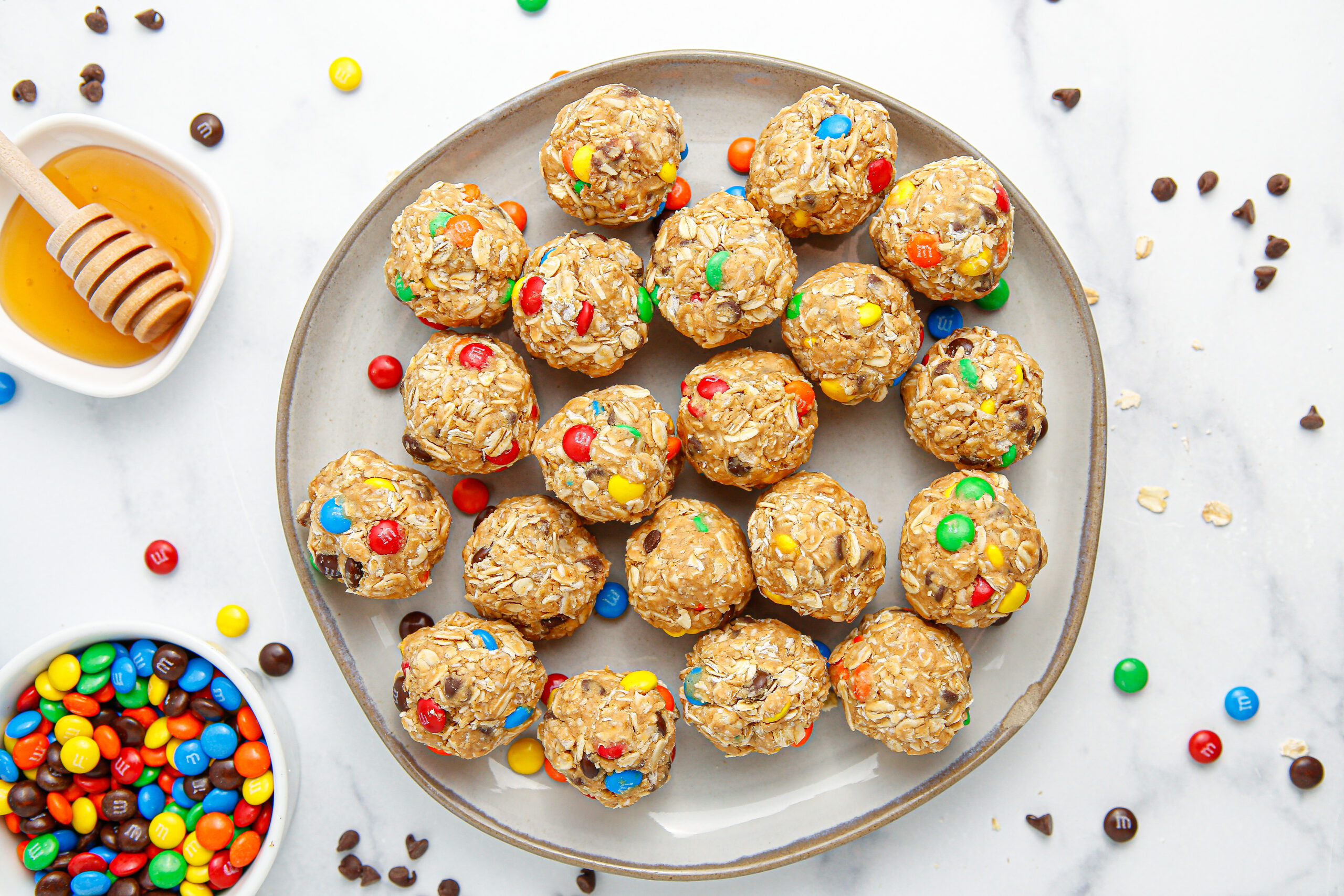 overhead view of No Bake M&M Energy balls on a large gray plate