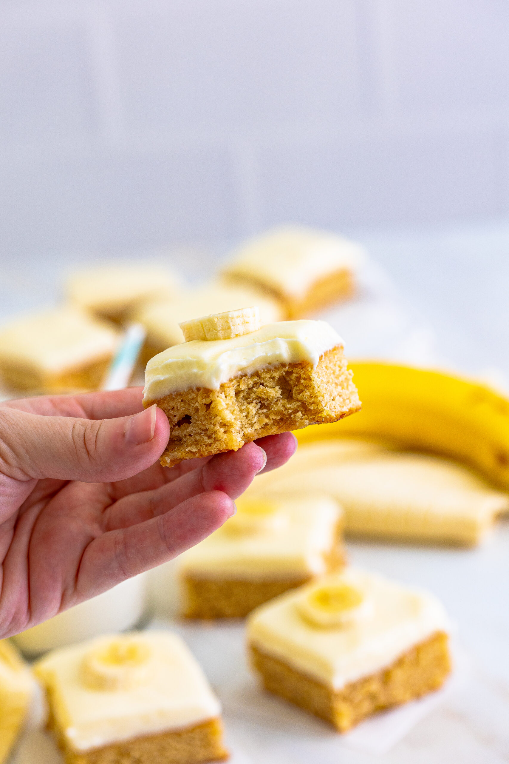 Front view of a Banana Brownie being held with a bite removed.