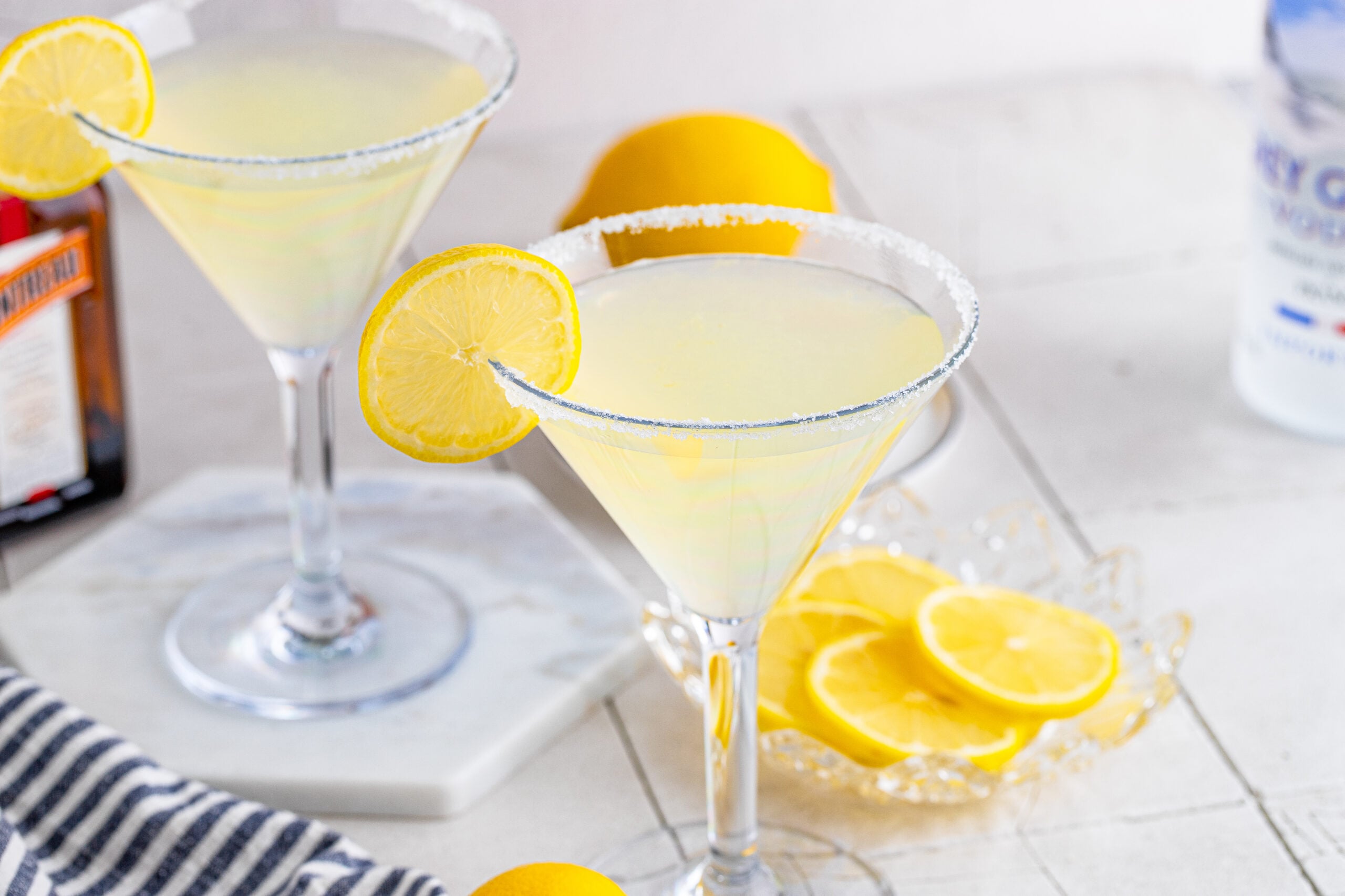 Two Lemon Drop Martinis in martini glasses with a lemon slice. 