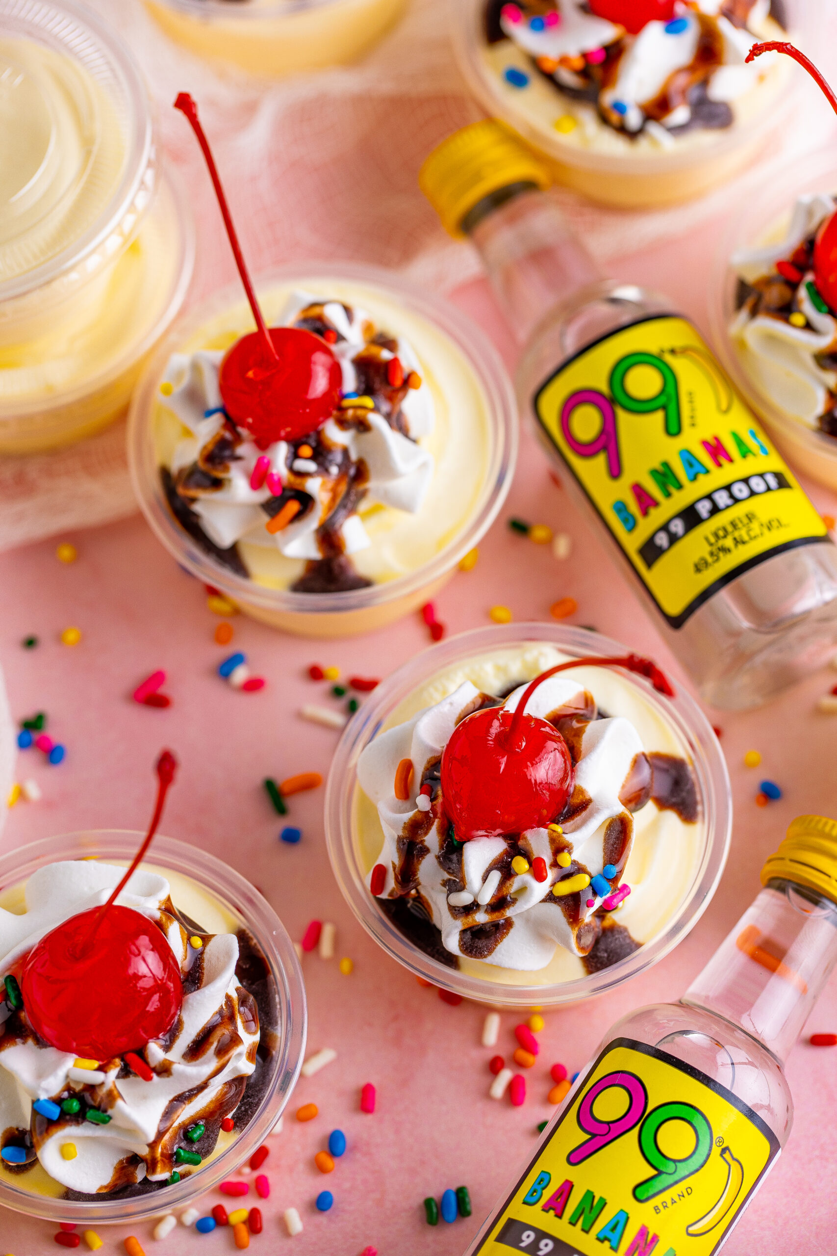 Overhead view of Banana Split Shots surrounded by rainbow sprinkles.