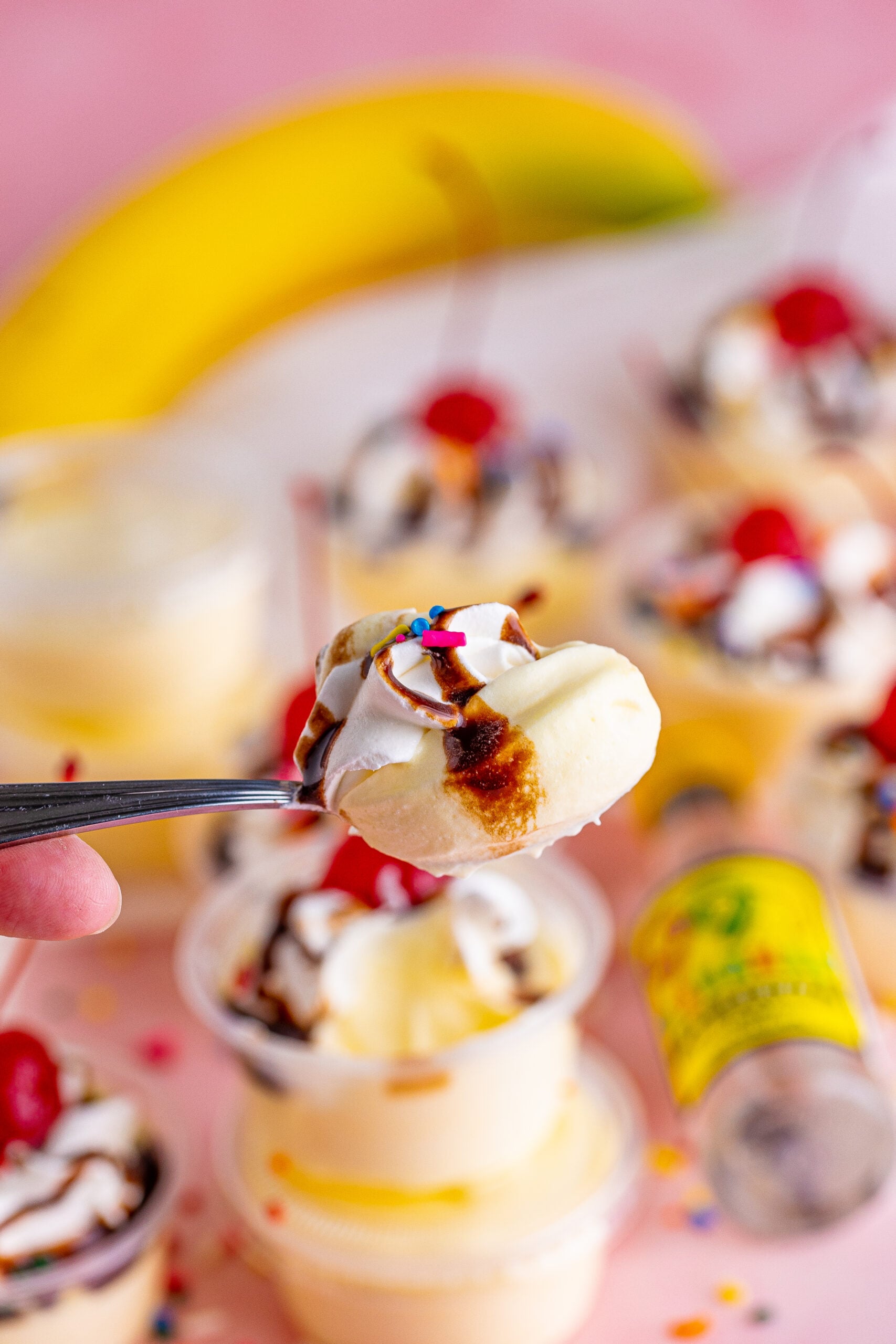 Silver spoon with a spoonful of Banana Split Shots.