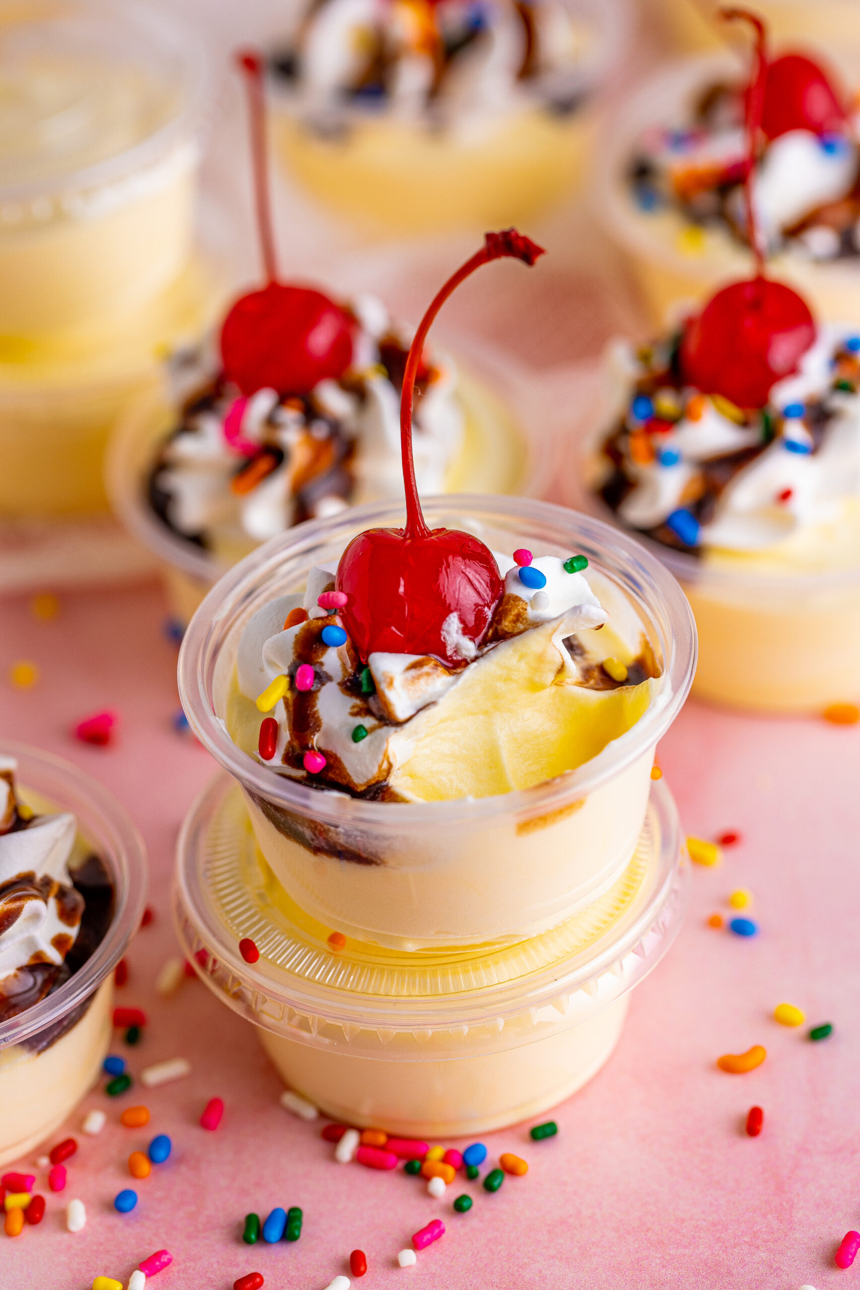 Side view of Banana Split Shots stacked with a spoon full removed from the top shot.