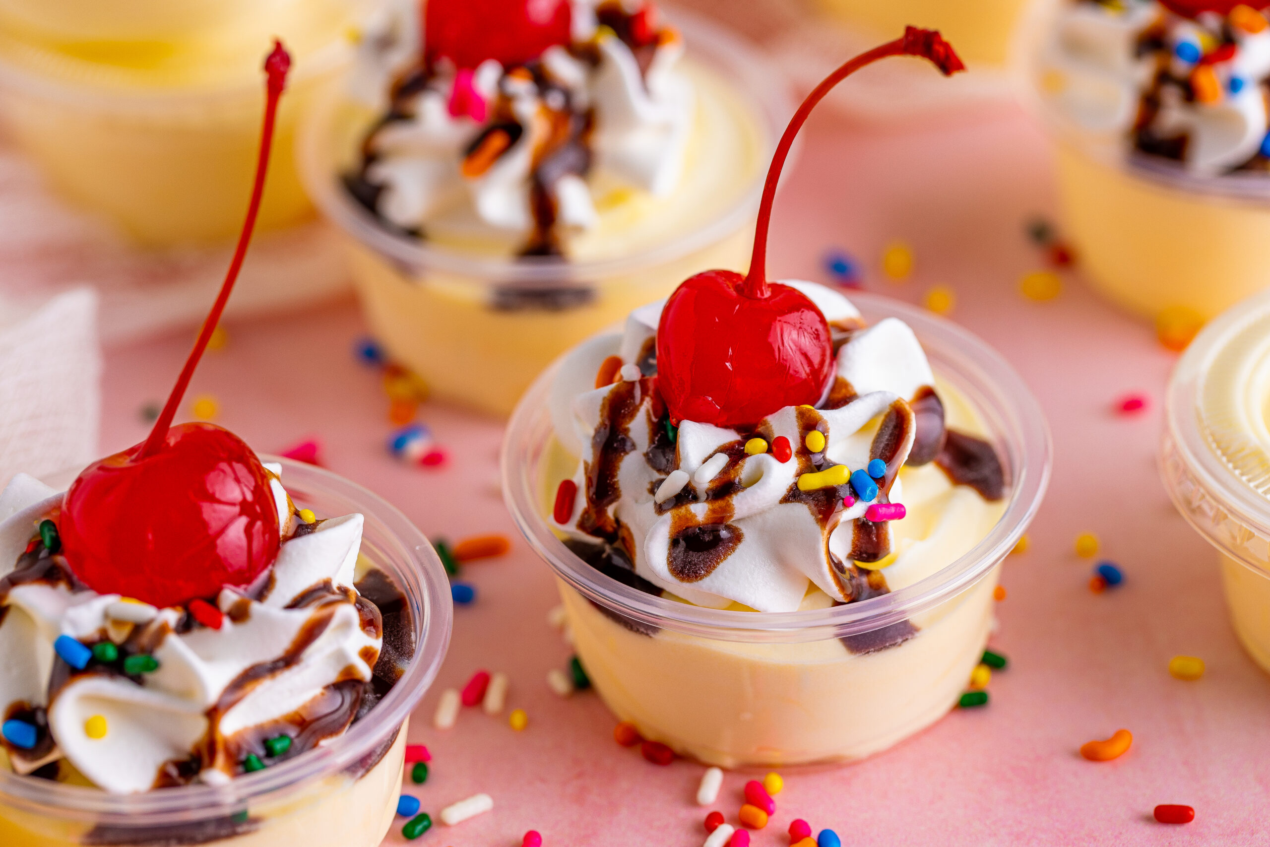 view of Banana Split Shots surrounded by rainbow sprinkles.