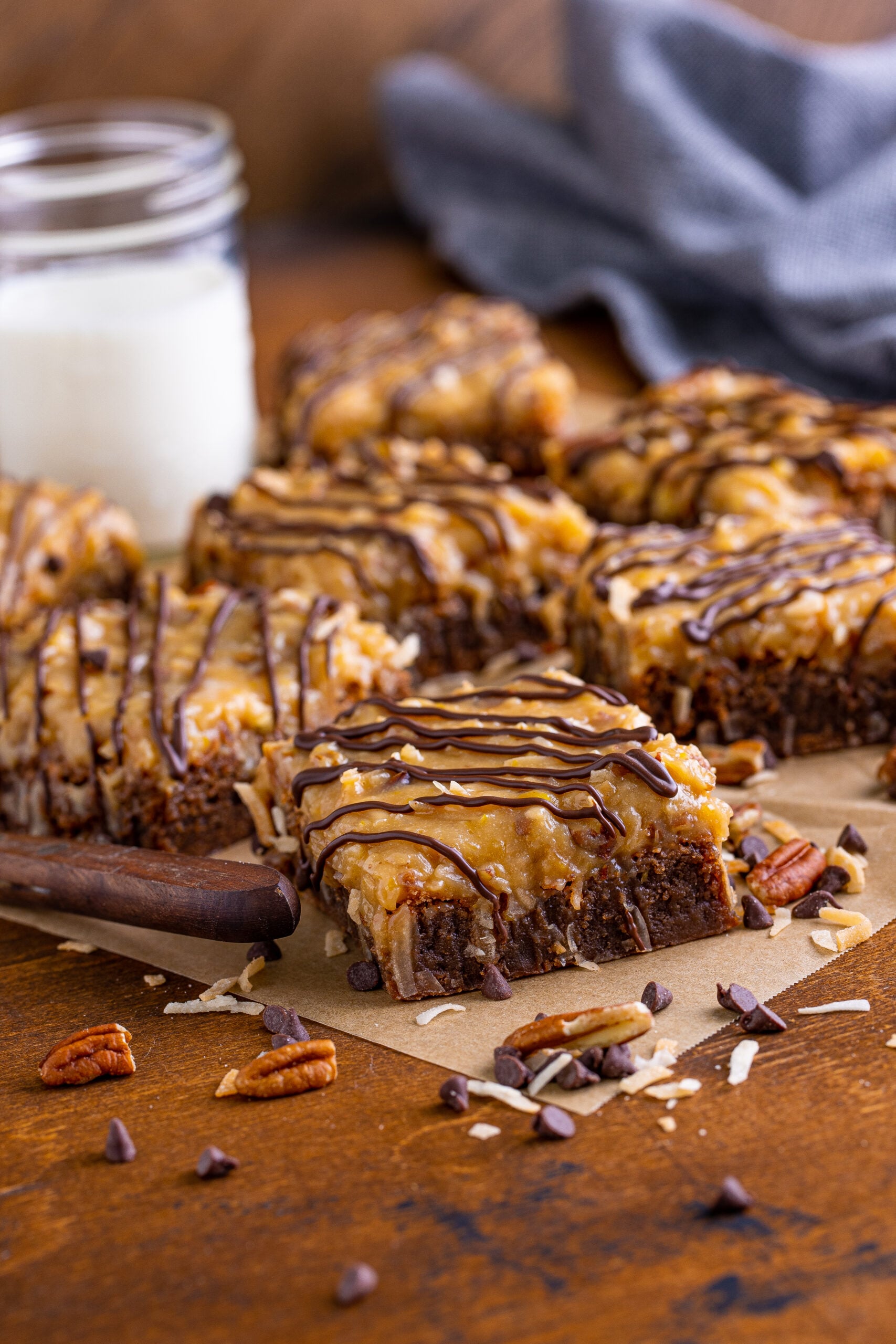 Side view of German Chocolate Brownies on a piece of parchment paper.