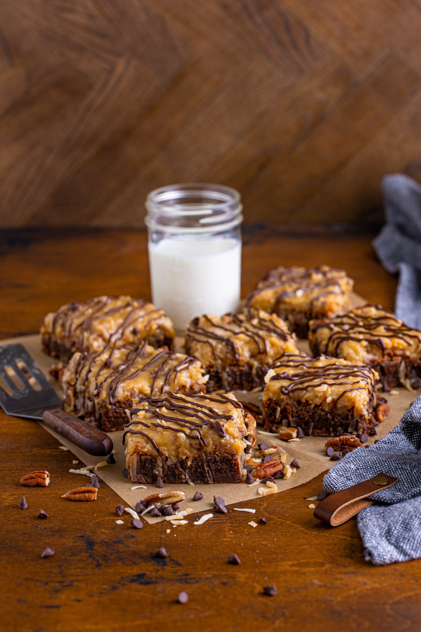 Front view of German Chocolate Brownies on a piece of parchment paper. 