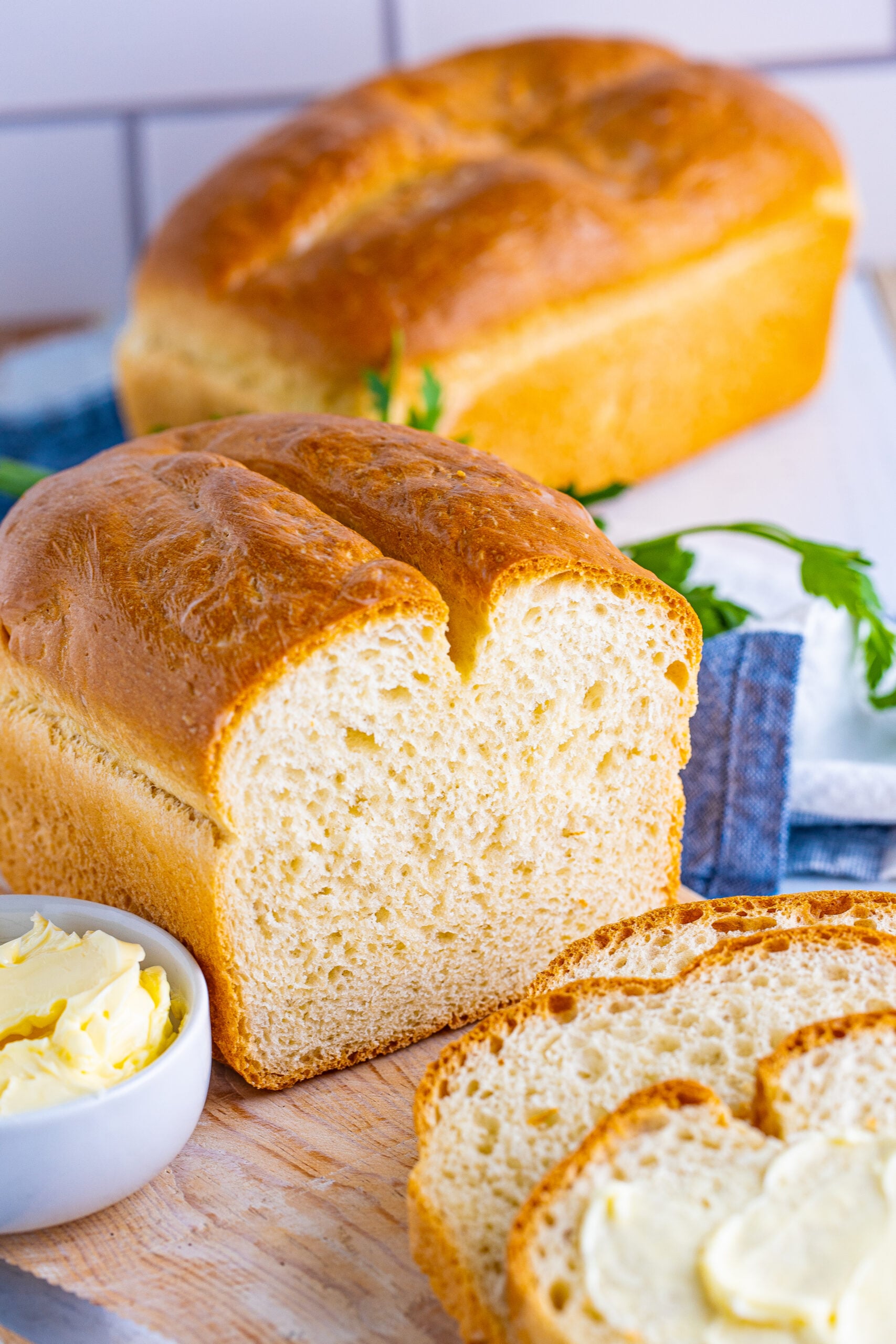 Front view of a loaf of White Bread with slices removed.