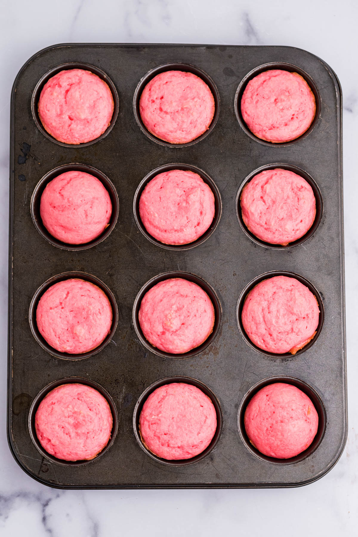 Overhead view of Weight Watchers Strawberry Muffins in a muffin pan.