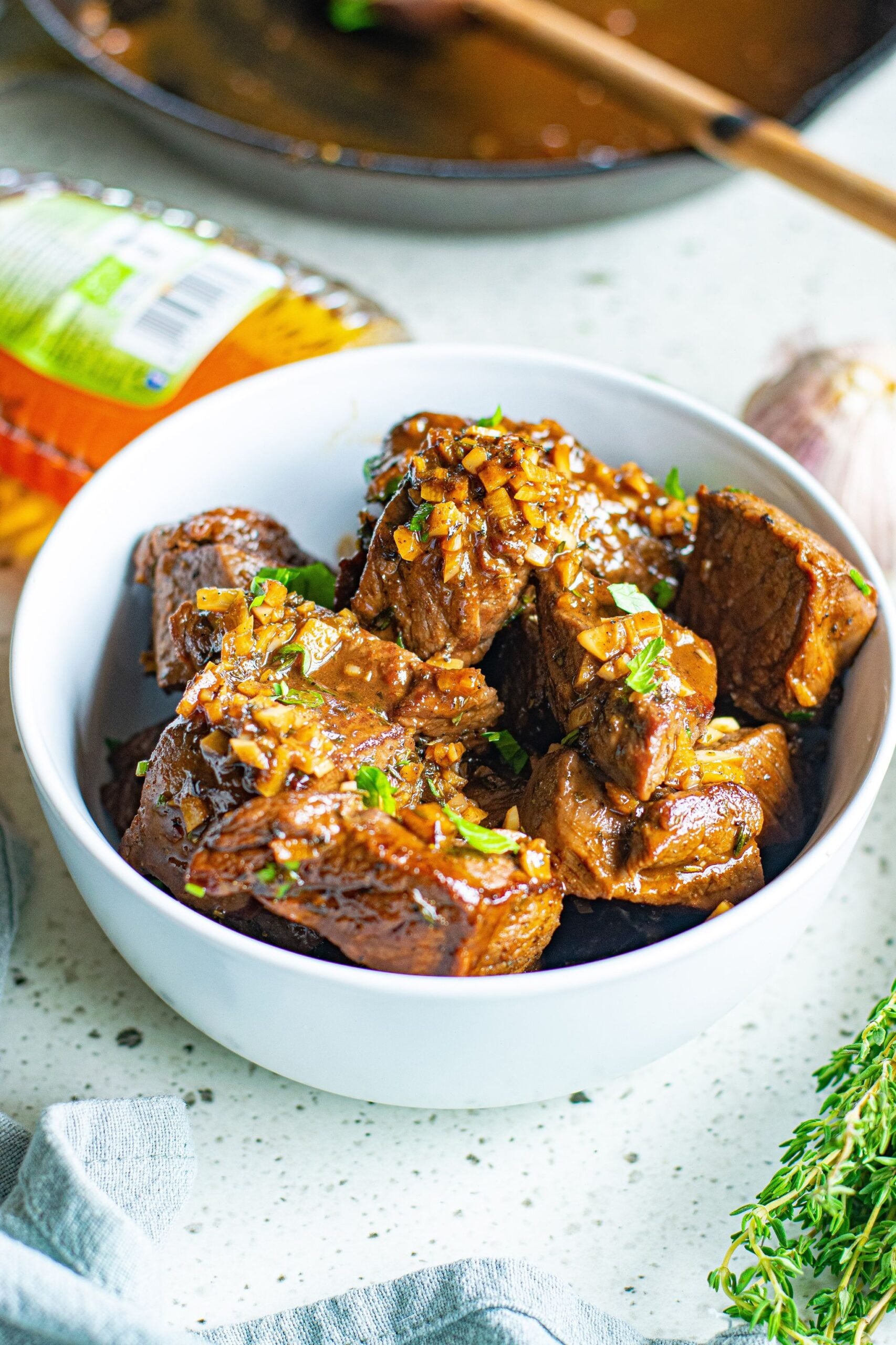 Front view of Garlic Honey Steak Bites in a white bowl.
