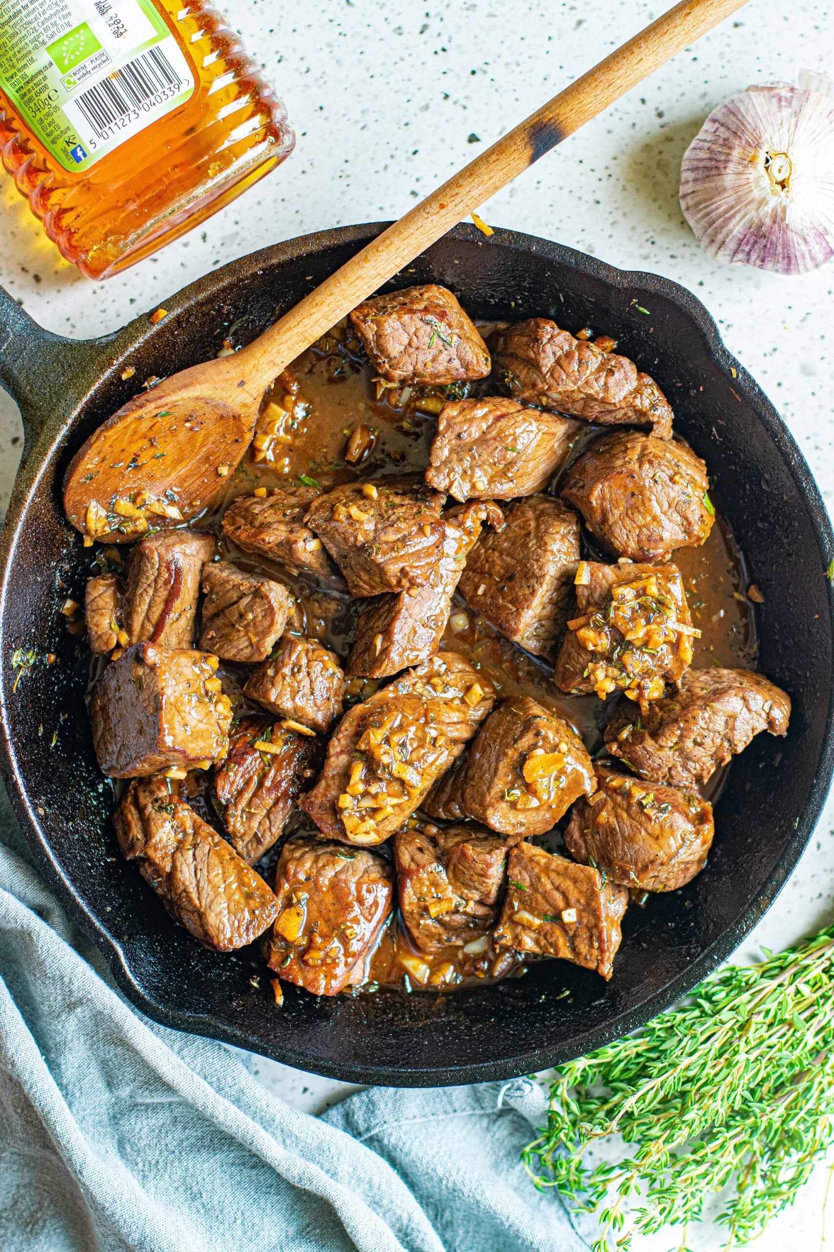Overhead view of Garlic Honey Steak Bites in a cast iron skillet.
