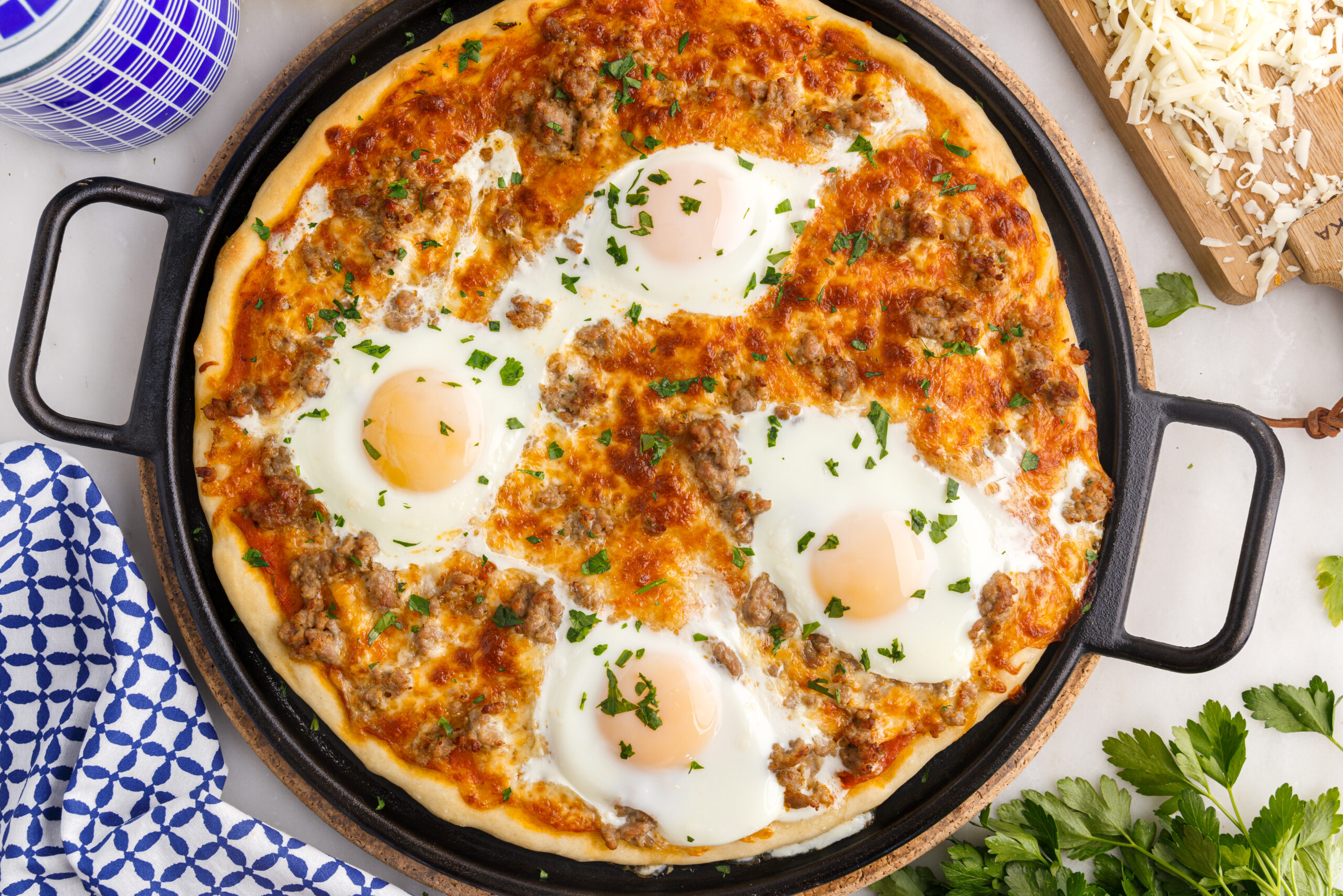 Overhead view of Breakfast Pizza on a black pizza dish.