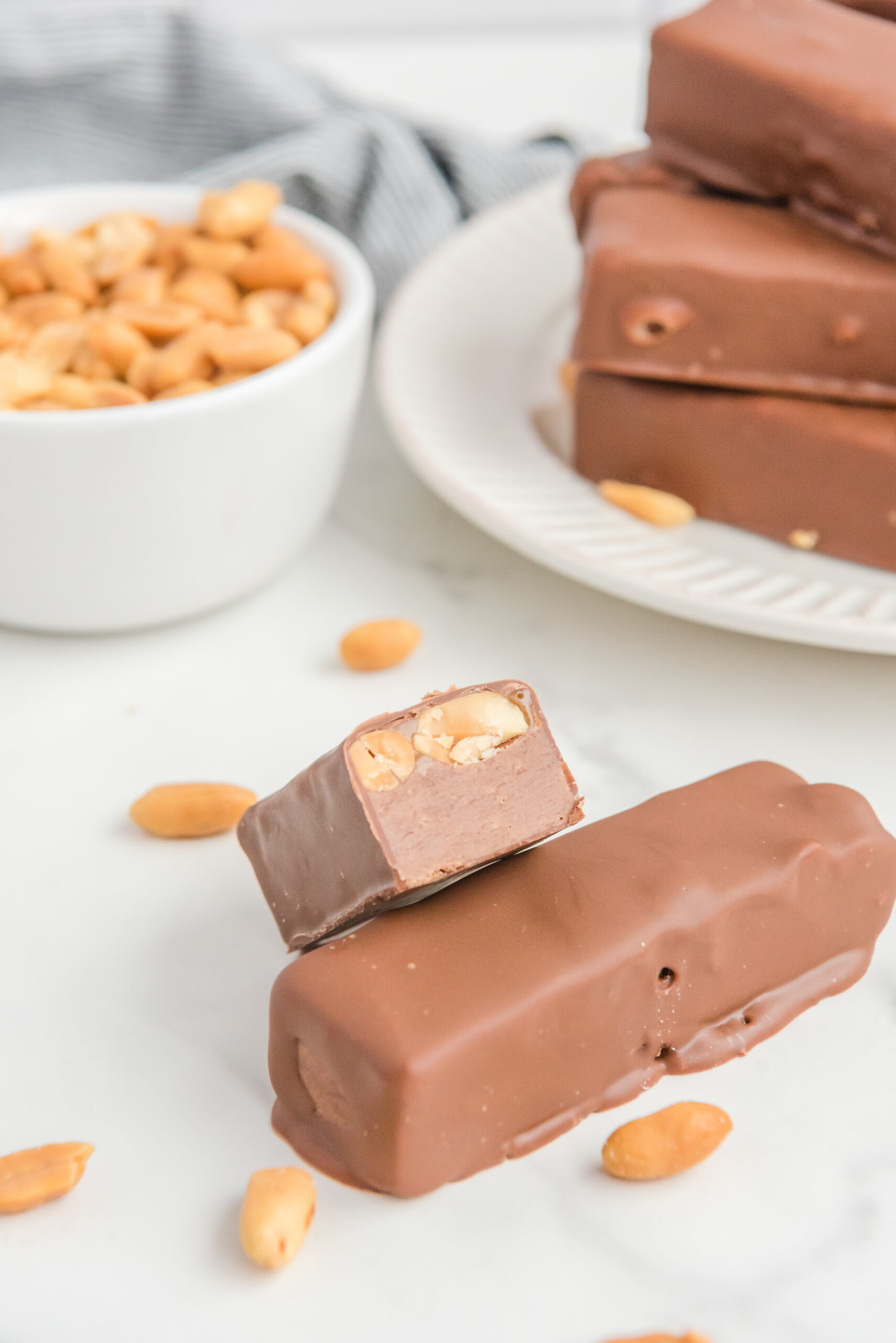 Front view of half of a Homemade Snickers Bars stacked onto a full bar.