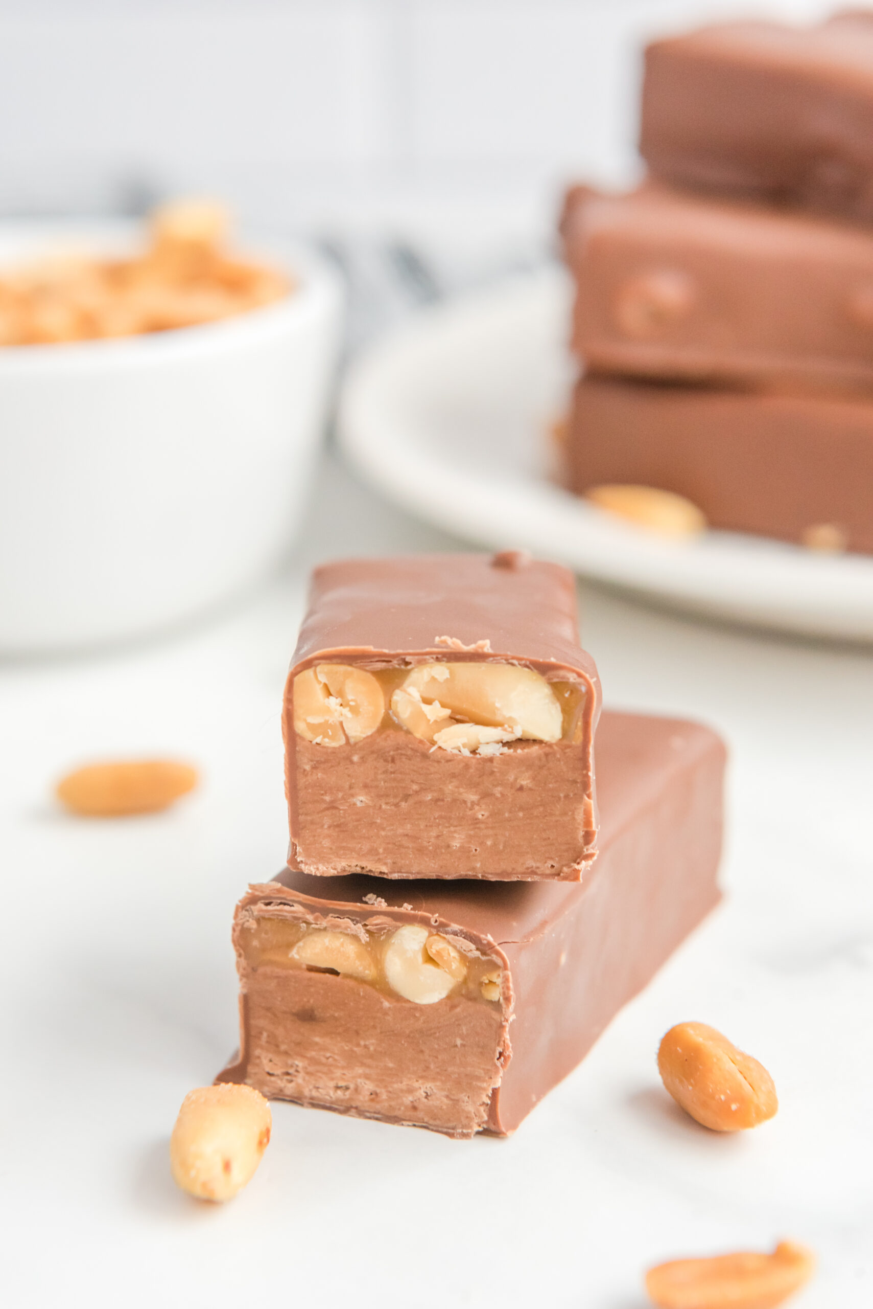 Front view of two halves of Homemade Snickers Bars stacked.