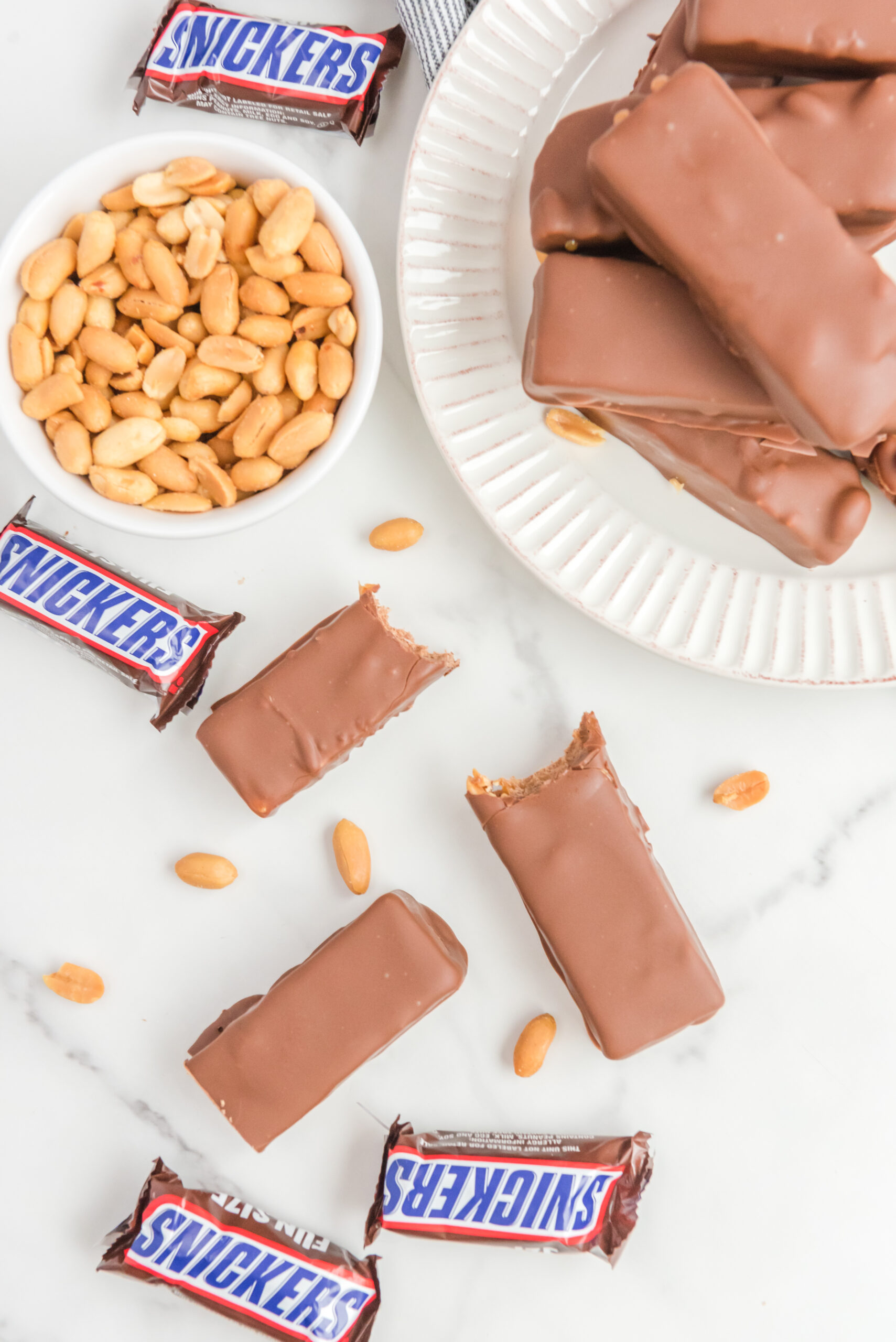 Overhead view of Homemade Snickers Bars with bites removed from two bars.