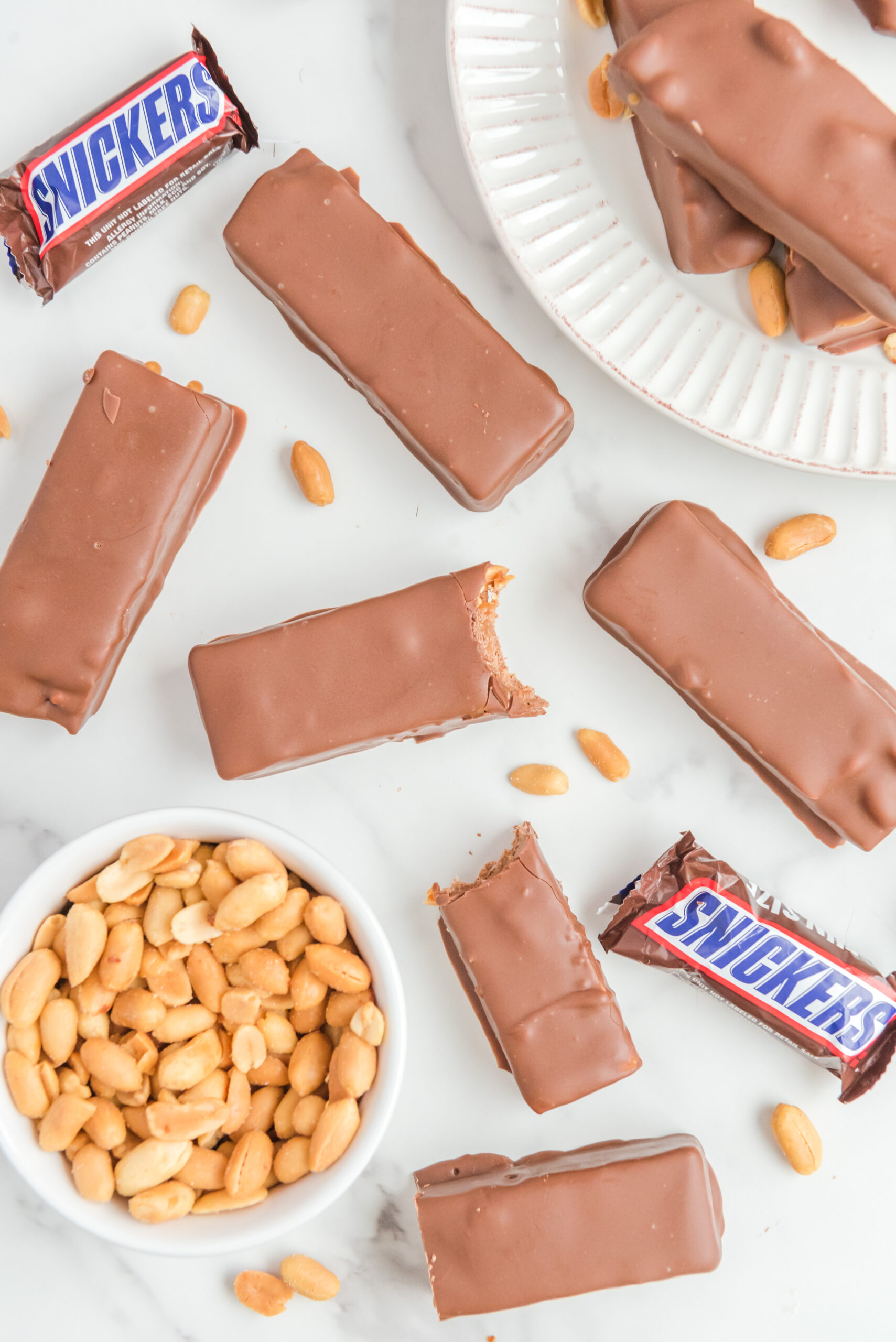 Overhead view of Homemade Snickers Bars with bites removed from two bars.