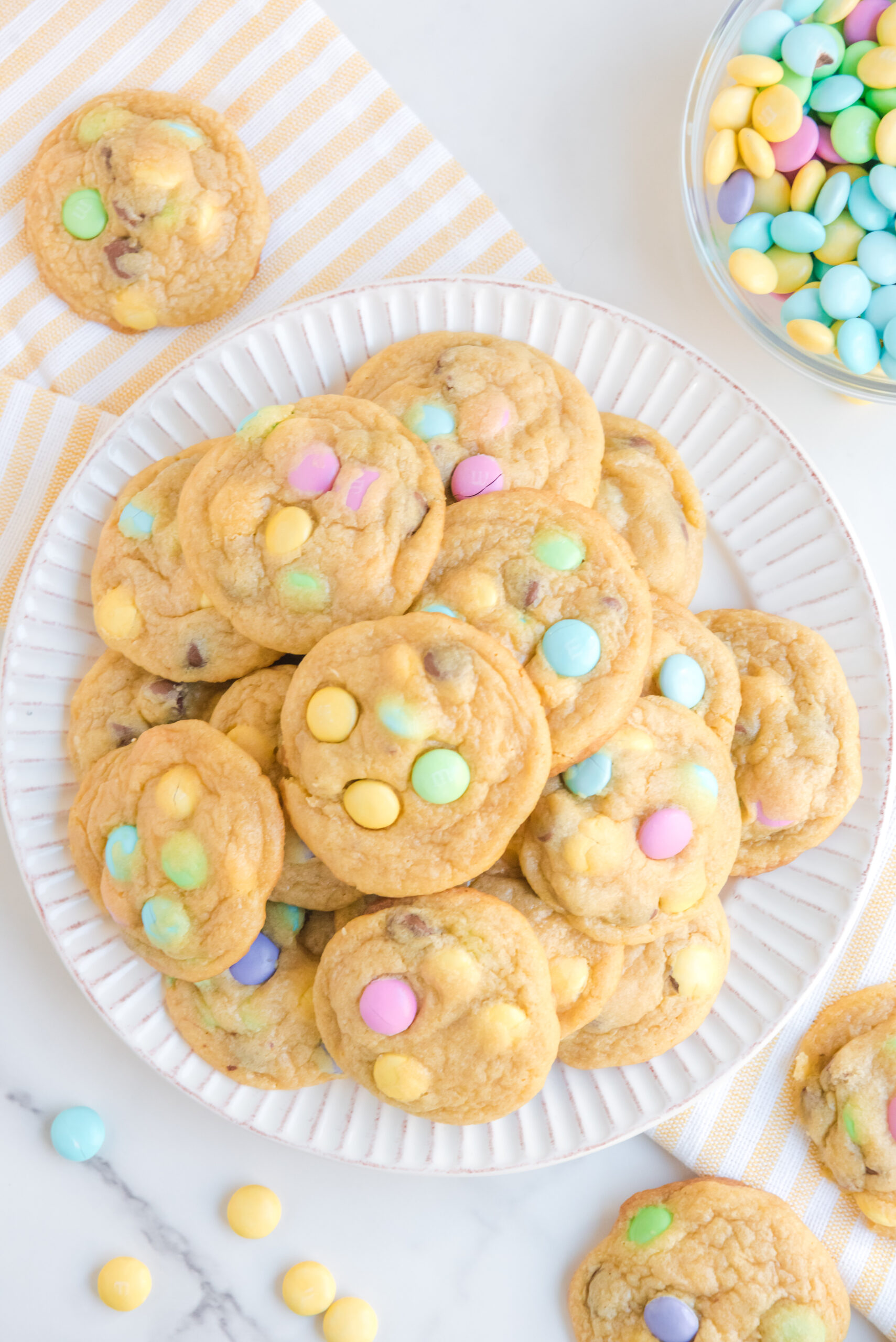 Overhead view of a stack of Easter Pudding Cookies on a white plate.