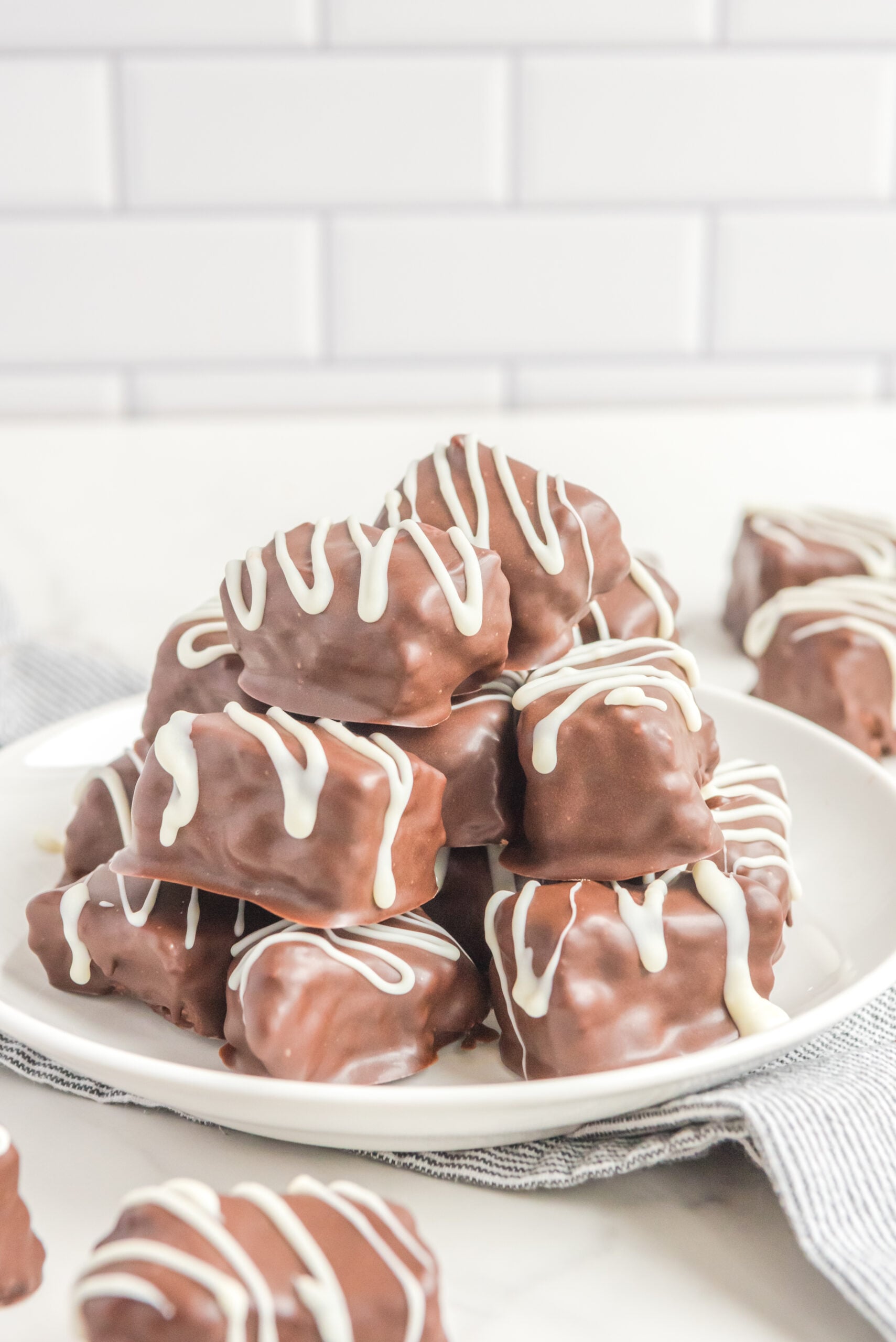 Front view of a stack of Cool Whip Candy on a white plate.