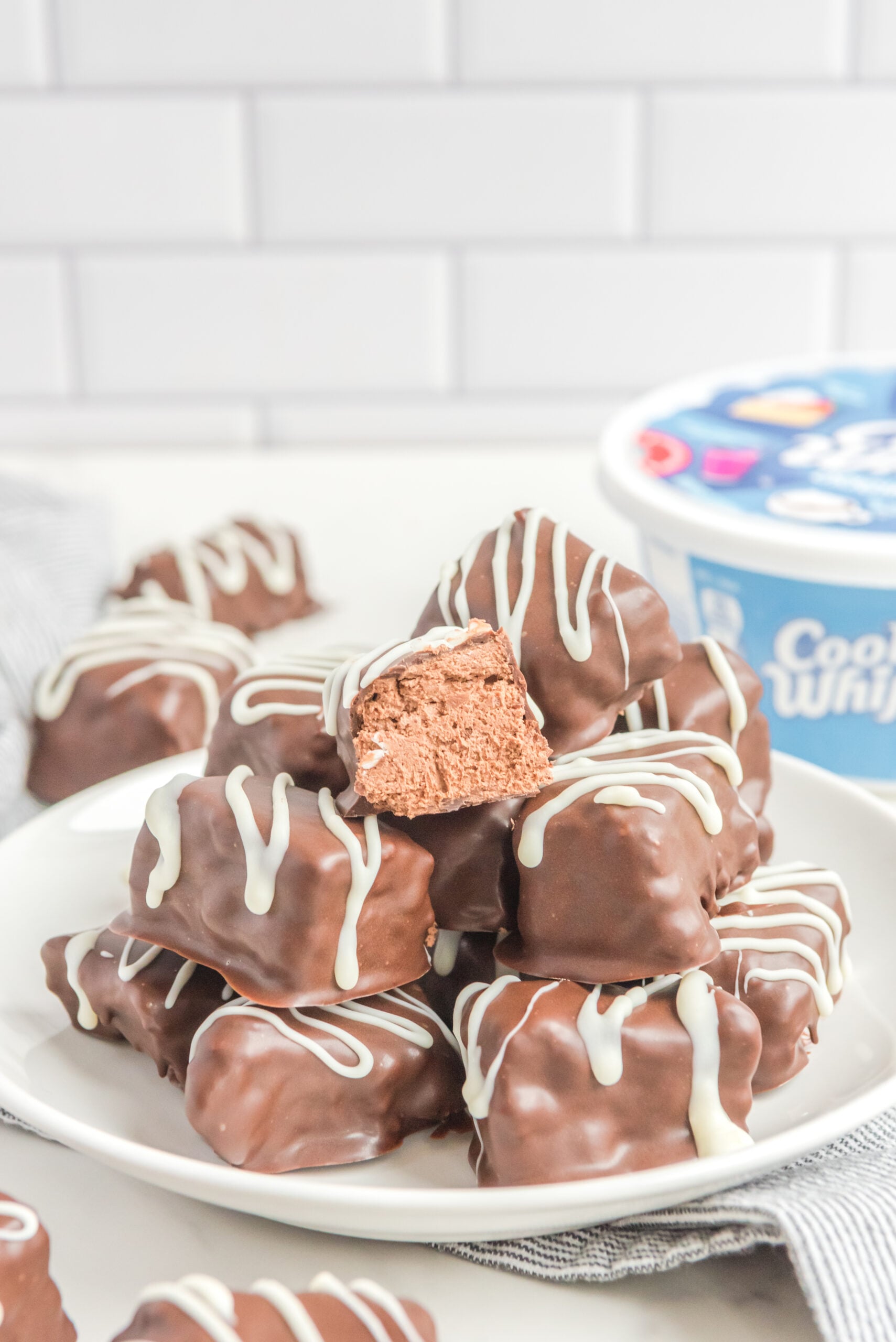 Front view of a stack of Cool Whip Candy on a white plate.