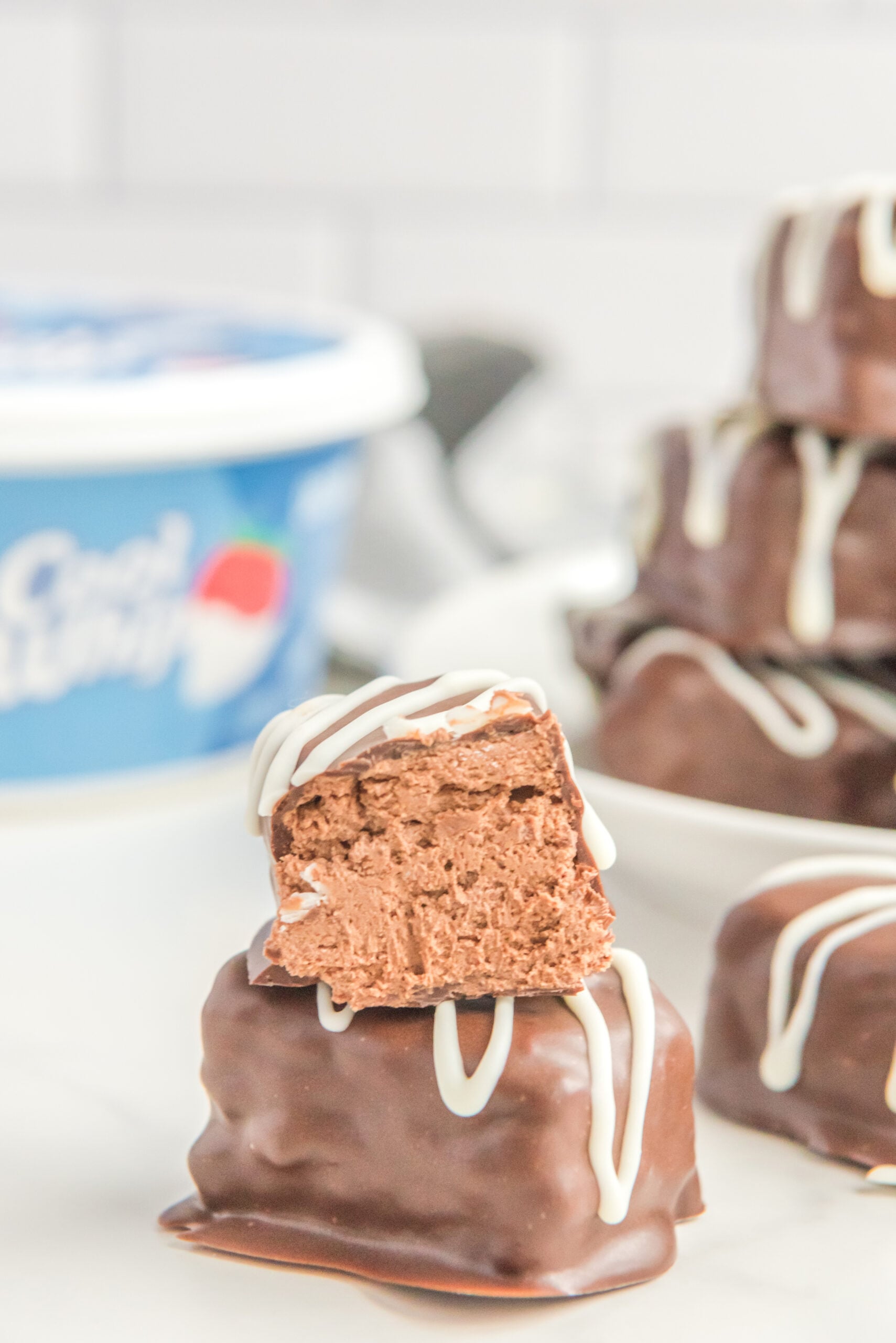 Front view of a half of a Cool Whip Candy stacked onto a full candy bar.