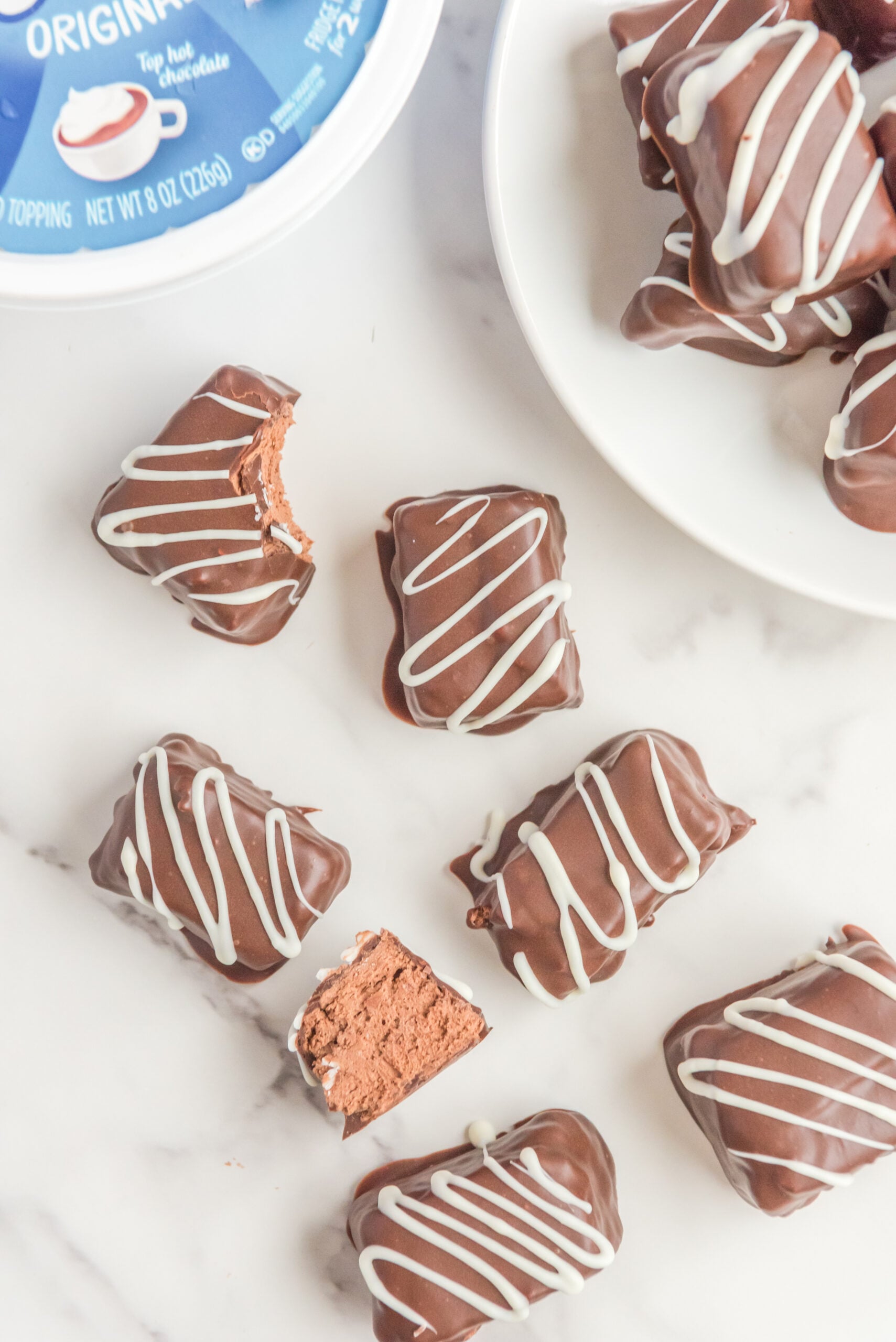 Overhead view of Cool Whip Candy with bites removed from two candy bars.