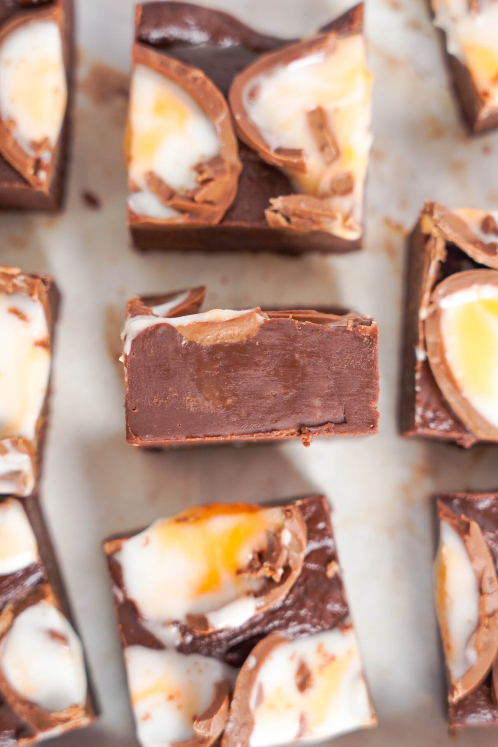 Close up view of a piece of Cadbury Cream Fudge on its side.