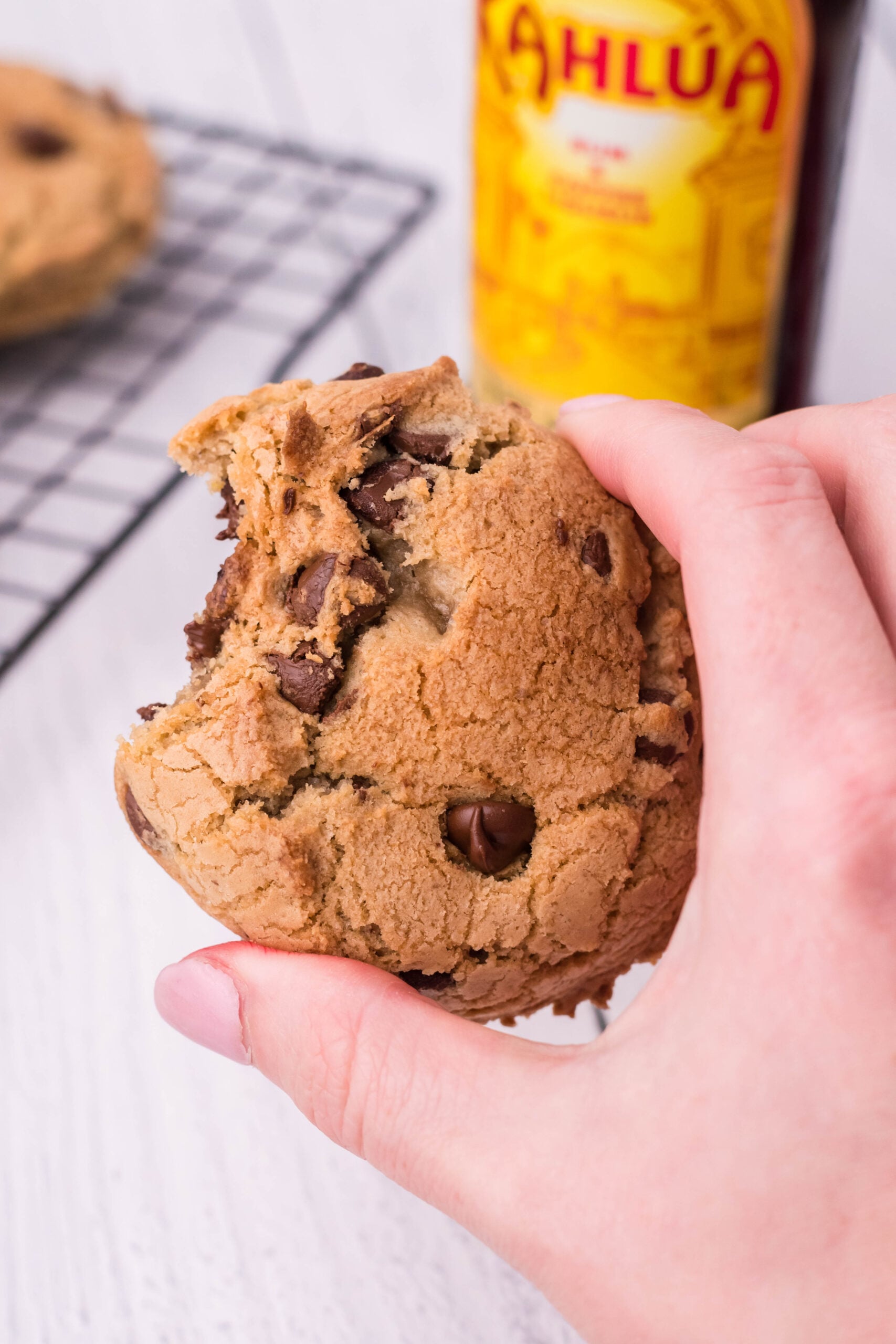Overhead view of a Kahlua Cookie being held with a bite removed.