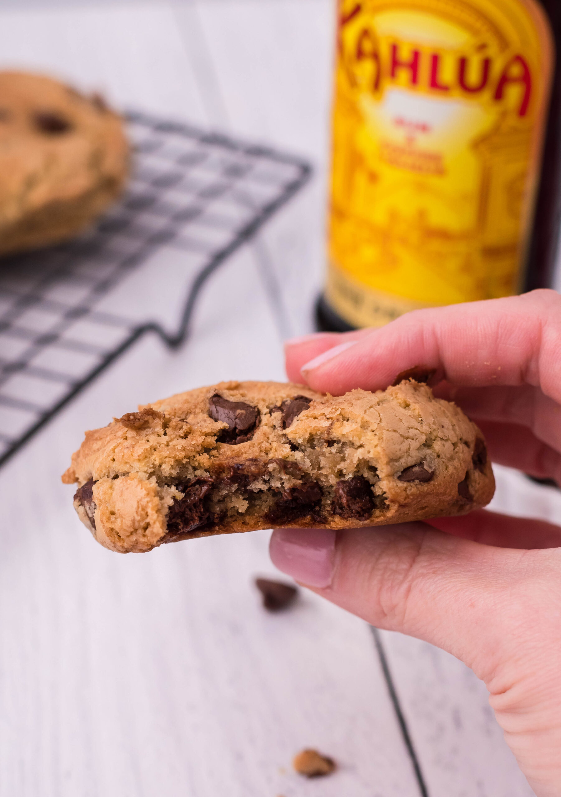 Front view of a Kahlua Cookie being held with a bite removed.