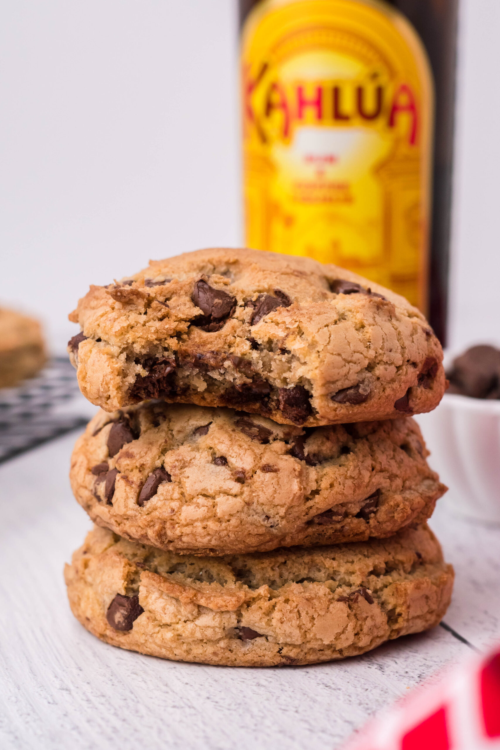 Front view of three Kahlua Cookies stacked with a bite removed from the top cookie.