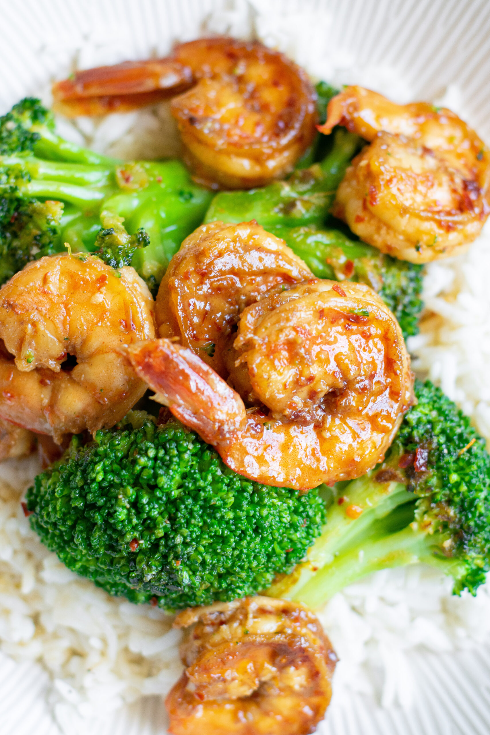 Close up view of the shrimp and broccoli plated over rice.