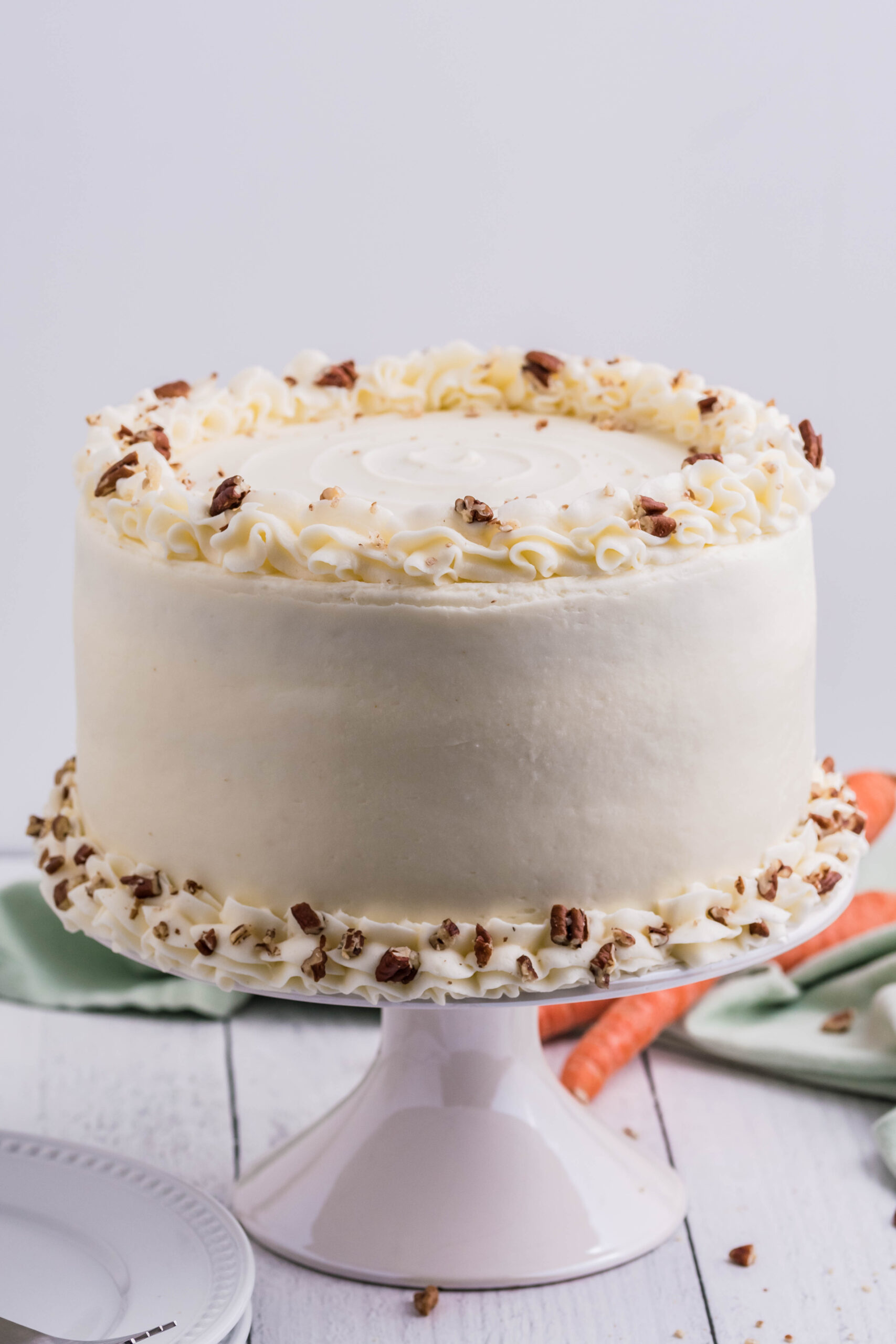 Front view of Carrot Cake on a white cake stand.